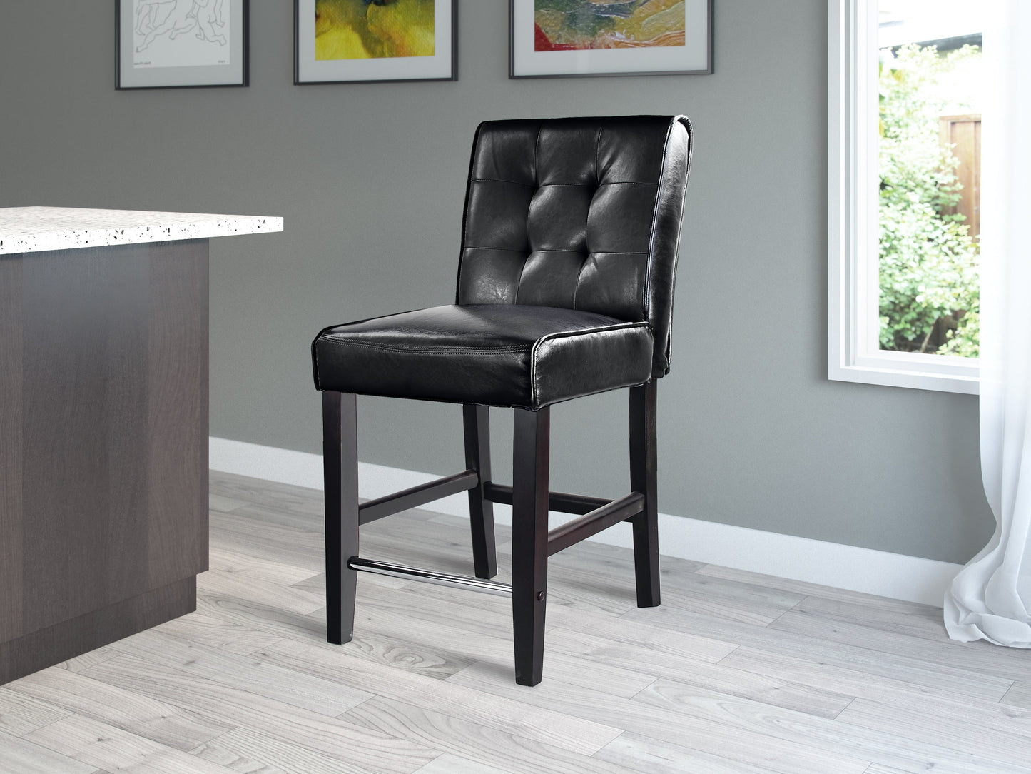 Black counter height bar stool with cushioned seat, sleek metal frame, and footrest, ideal for modern kitchen islands.