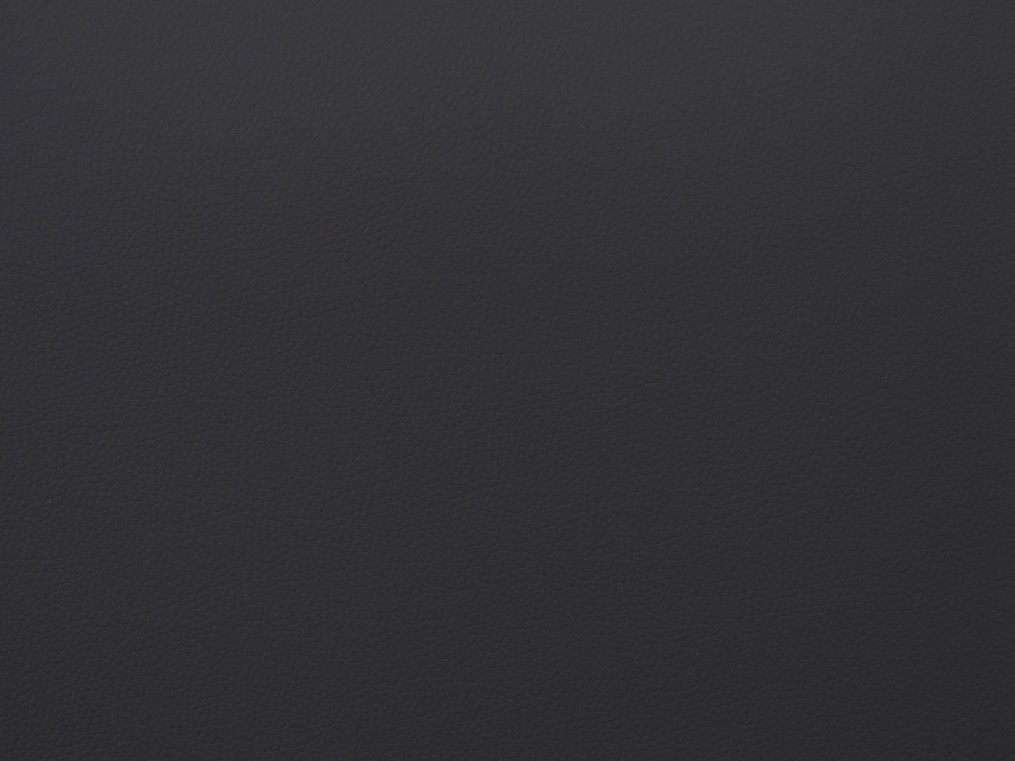 Vegan leather storage ottoman in light grey with tufted top and wooden legs.