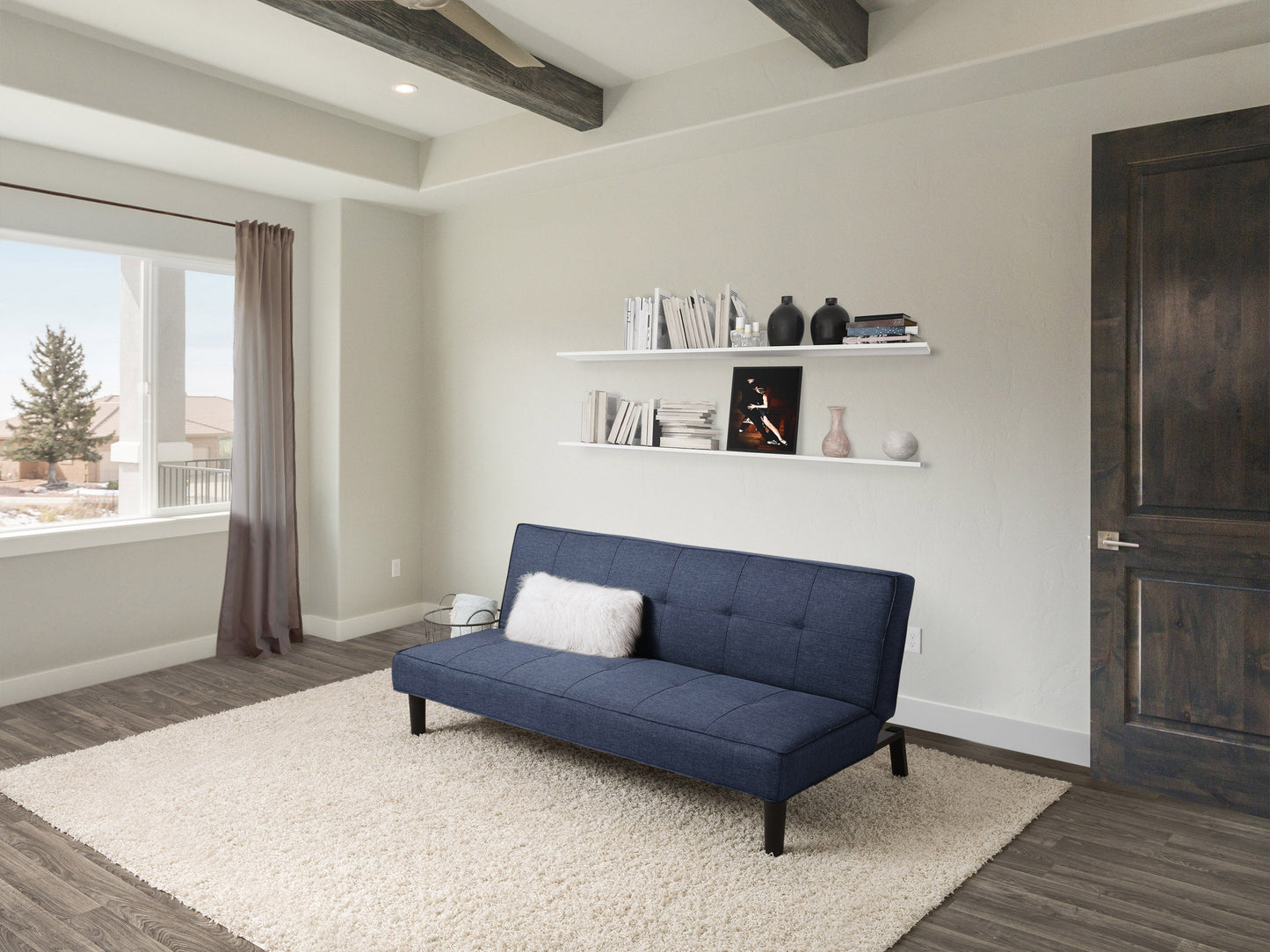 Blue fabric futon sofa bed with wooden legs, convertible design, and tufted cushions.