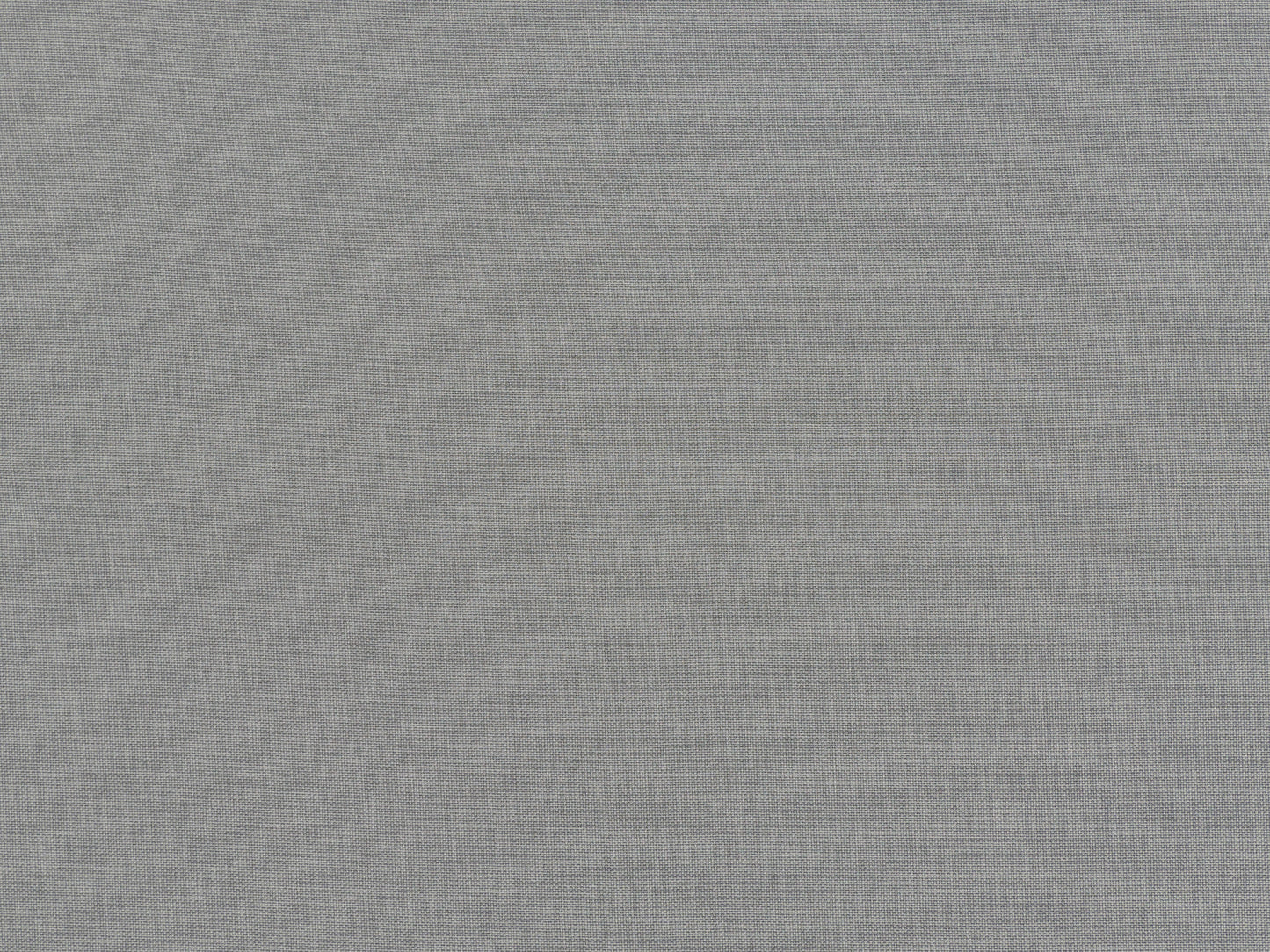 Light grey fabric ottoman with tufted top and wooden legs, perfect for modern living rooms.