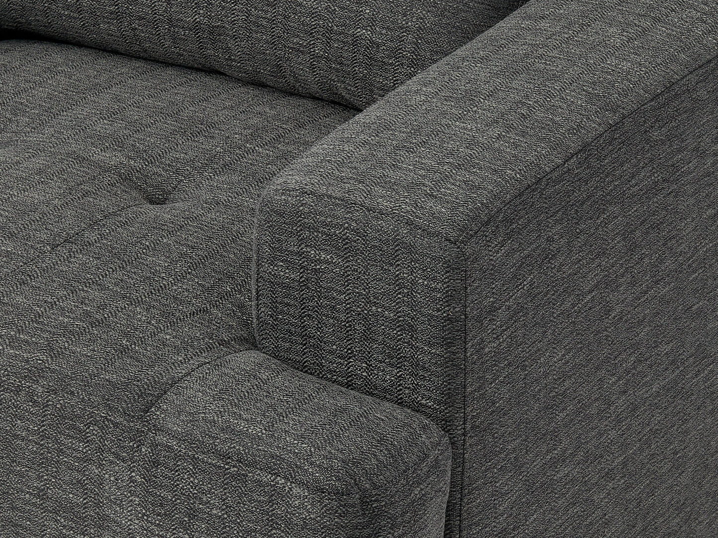 Dark grey mid-century armchair with wooden legs, tufted backrest, and sleek design.