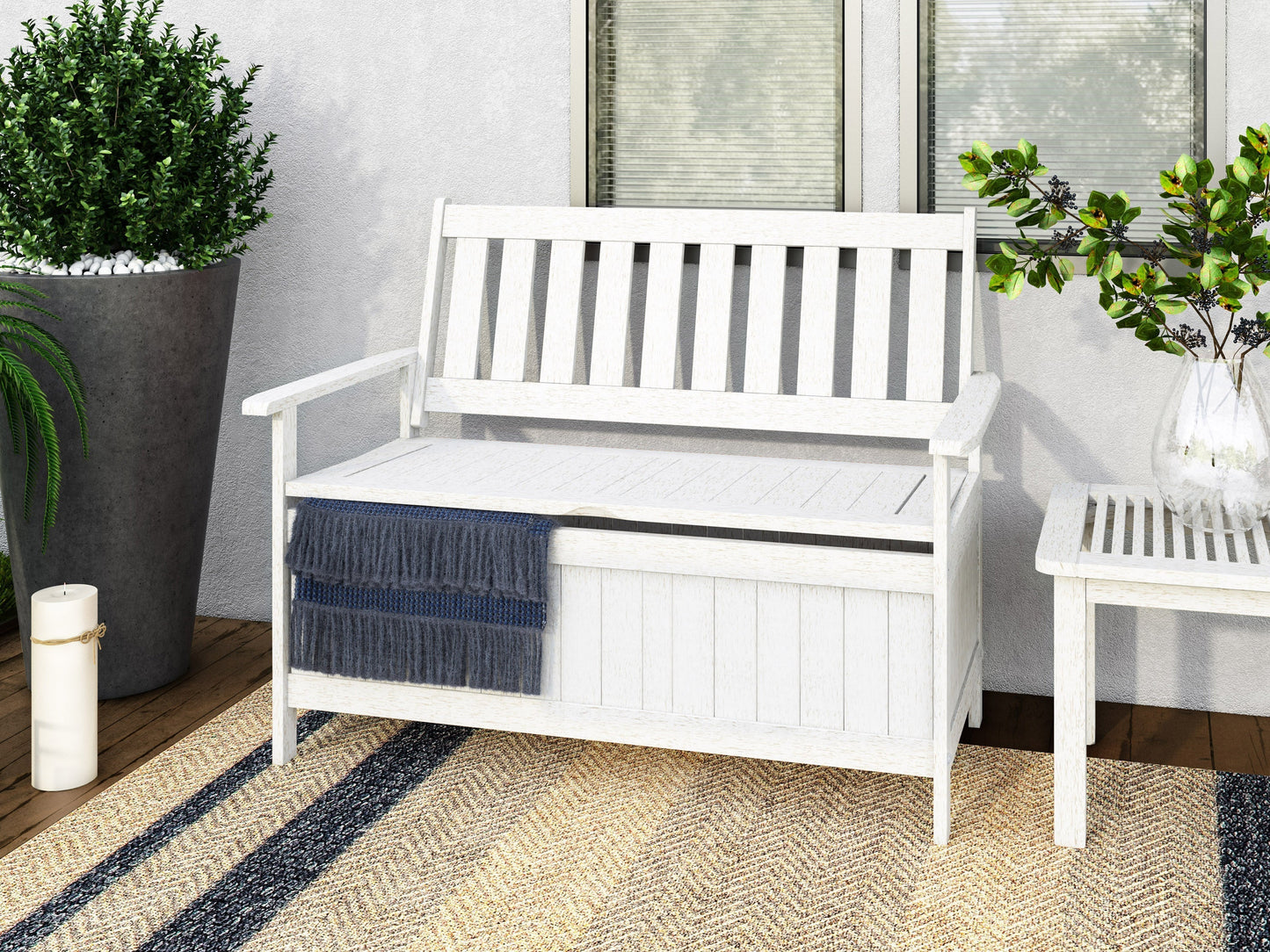 Washed white wooden patio storage bench with slatted backrest and seat, weather-resistant finish, and classic design.
