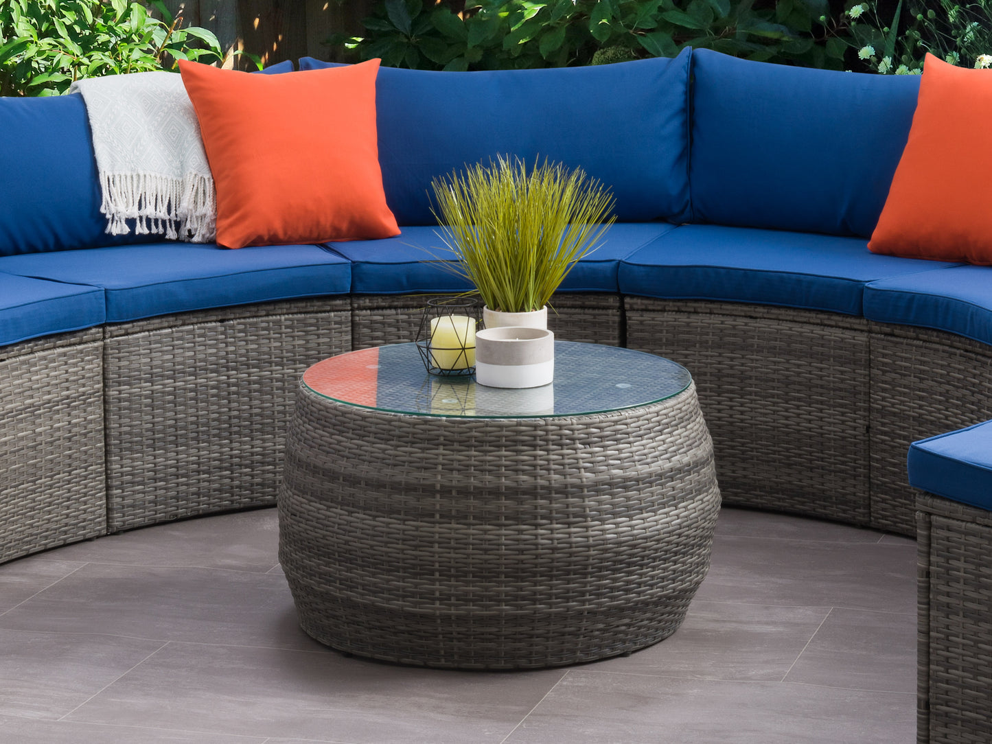 Wicker coffee table with a rectangular glass top, natural brown rattan weave, and sturdy aluminum frame, perfect for outdoor patio settings.