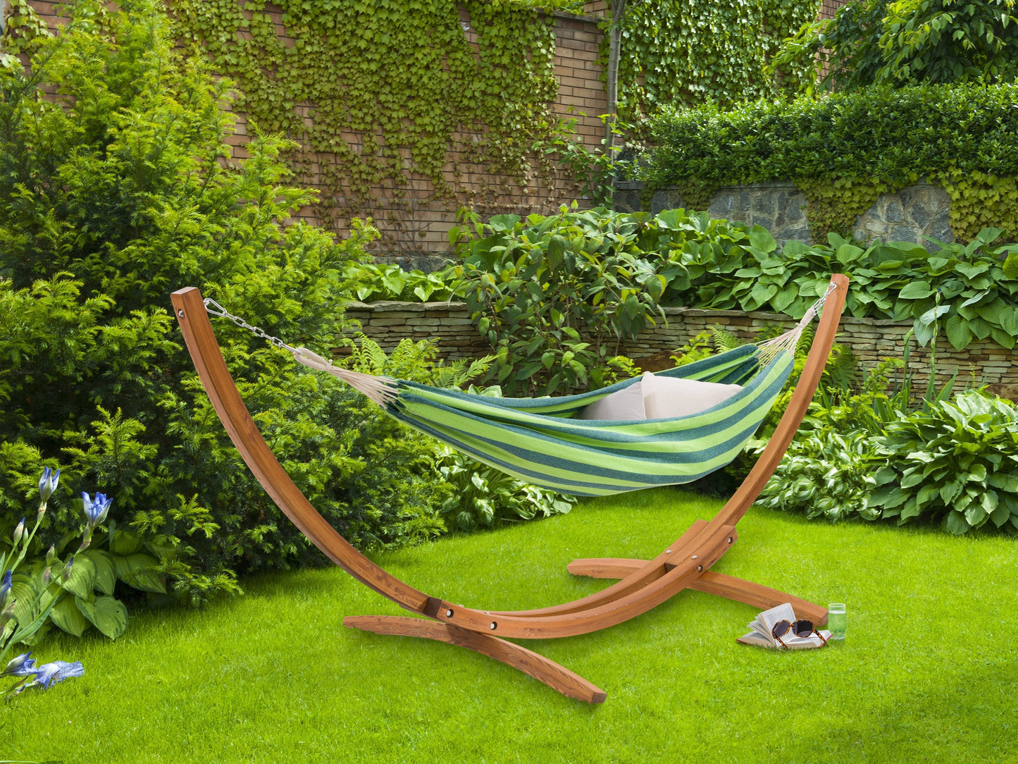 Blue and green patio hammock with wooden stand, outdoor relaxation furniture, durable fabric, and weather-resistant design.