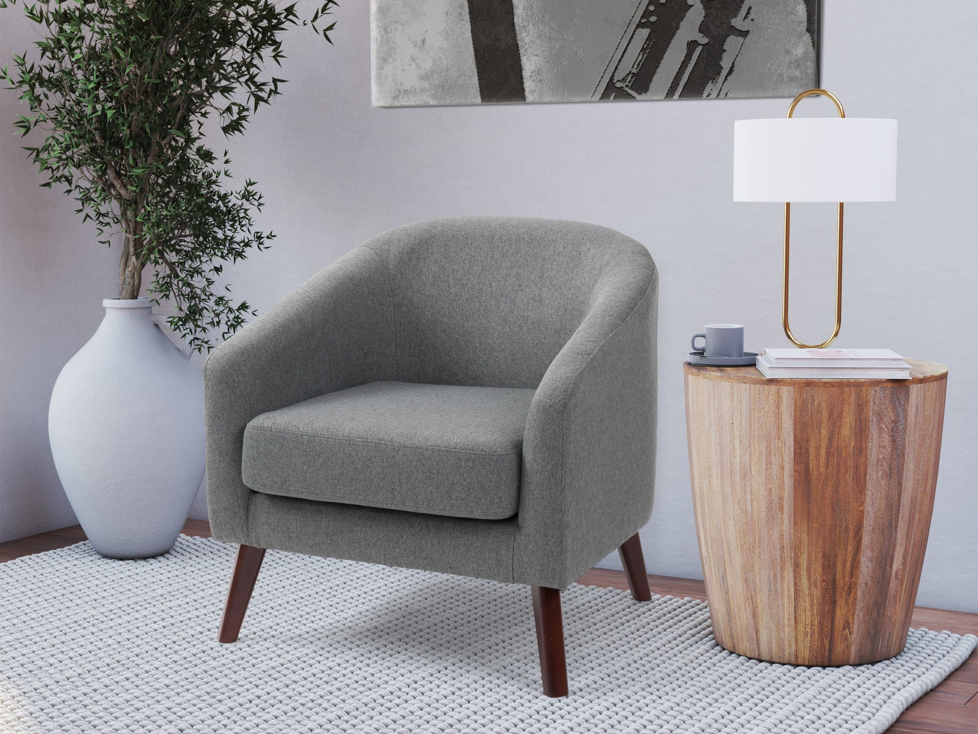 Gray fabric tub chair with wooden legs, featuring a curved back and armrests, providing a modern and comfortable seating option for living rooms or offices.