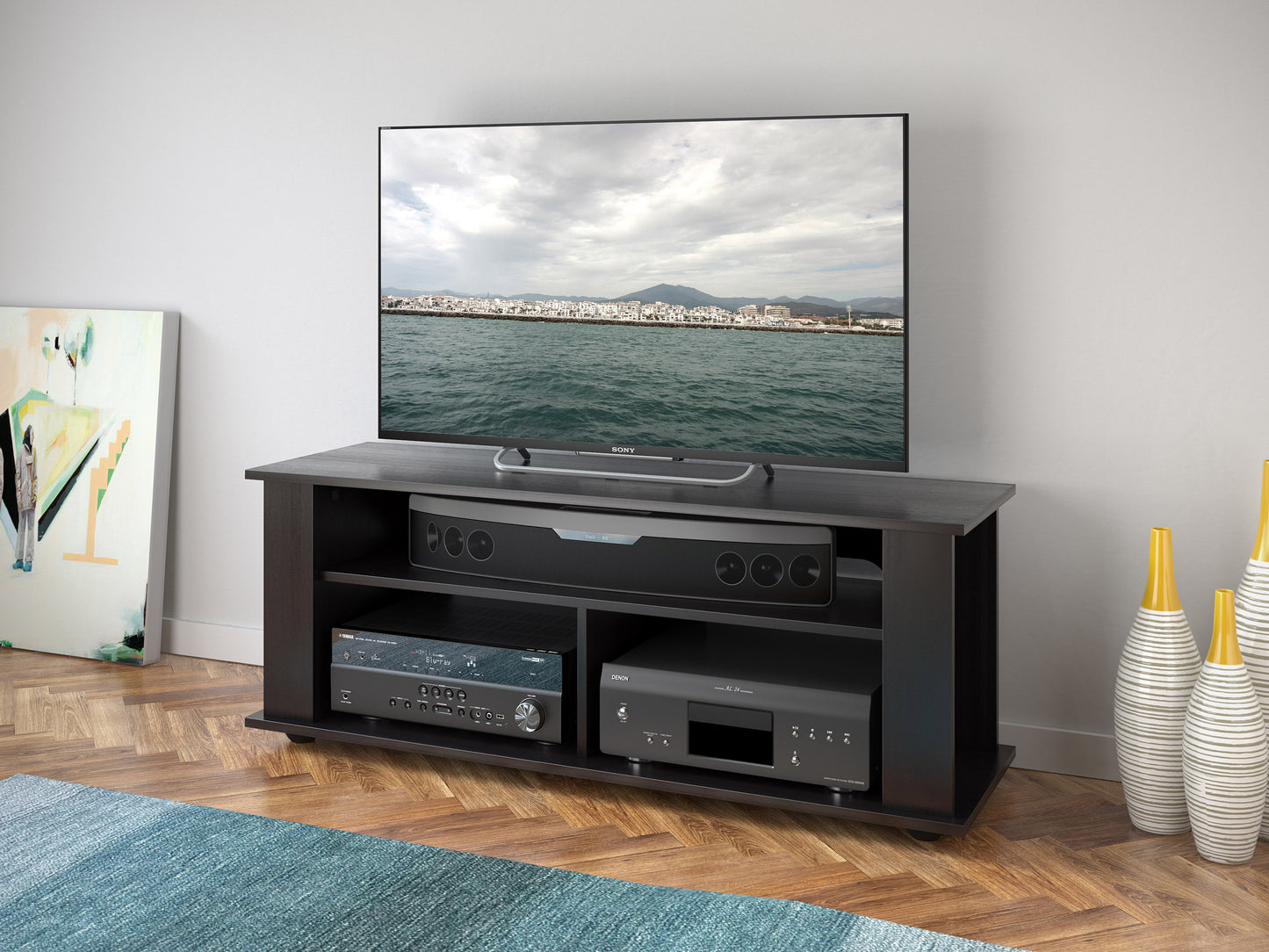 Modern TV stand with three-tiered glass shelves, sleek black metal frame, and cable management system; perfect for contemporary living rooms or entertainment spaces.