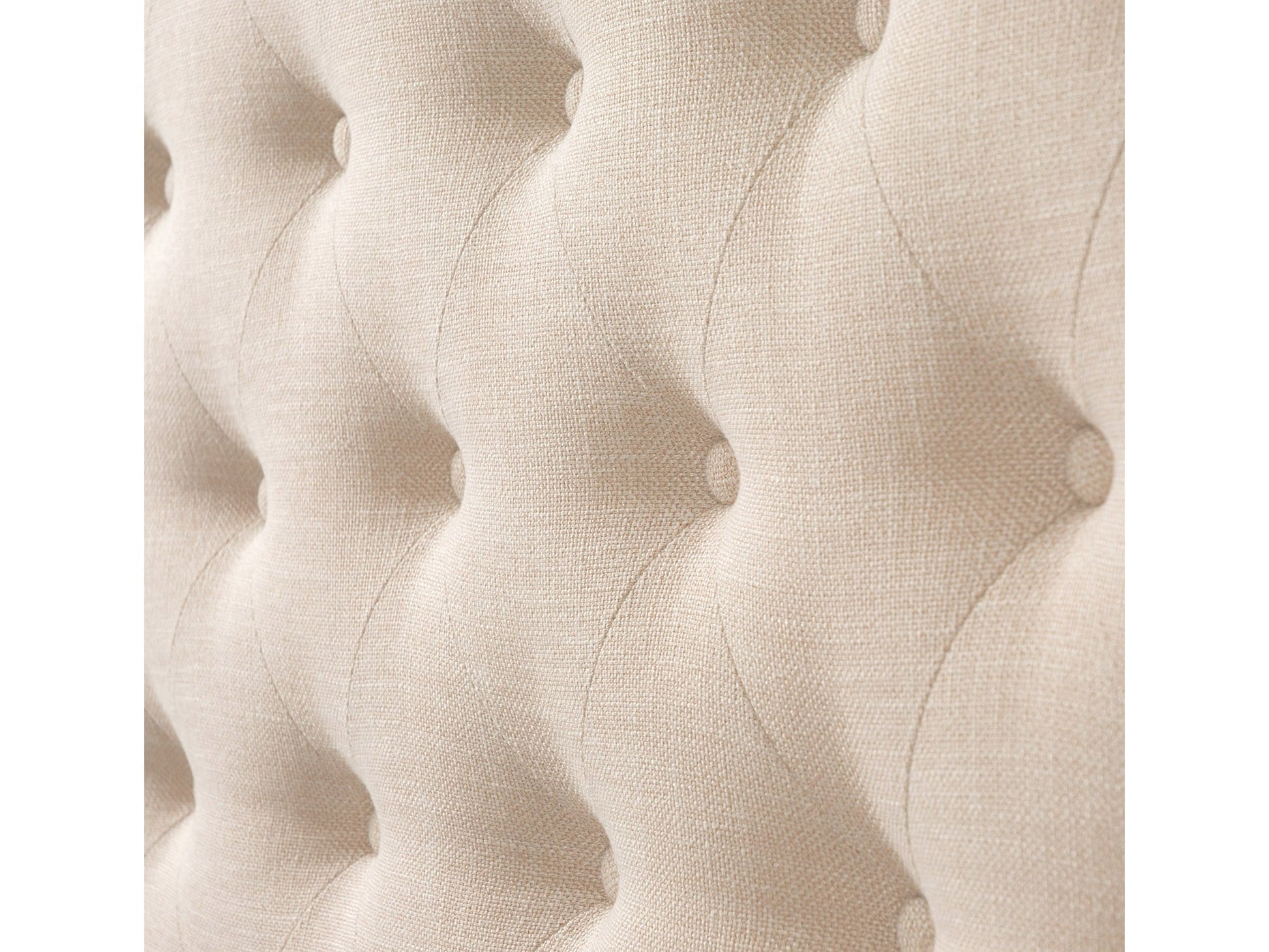 Cream tufted queen bed with wooden legs and upholstered headboard, elegant and modern bedroom furniture.