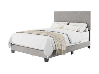 Blue-gray upholstered bed with white linens and beige knit throw, angled perspective.