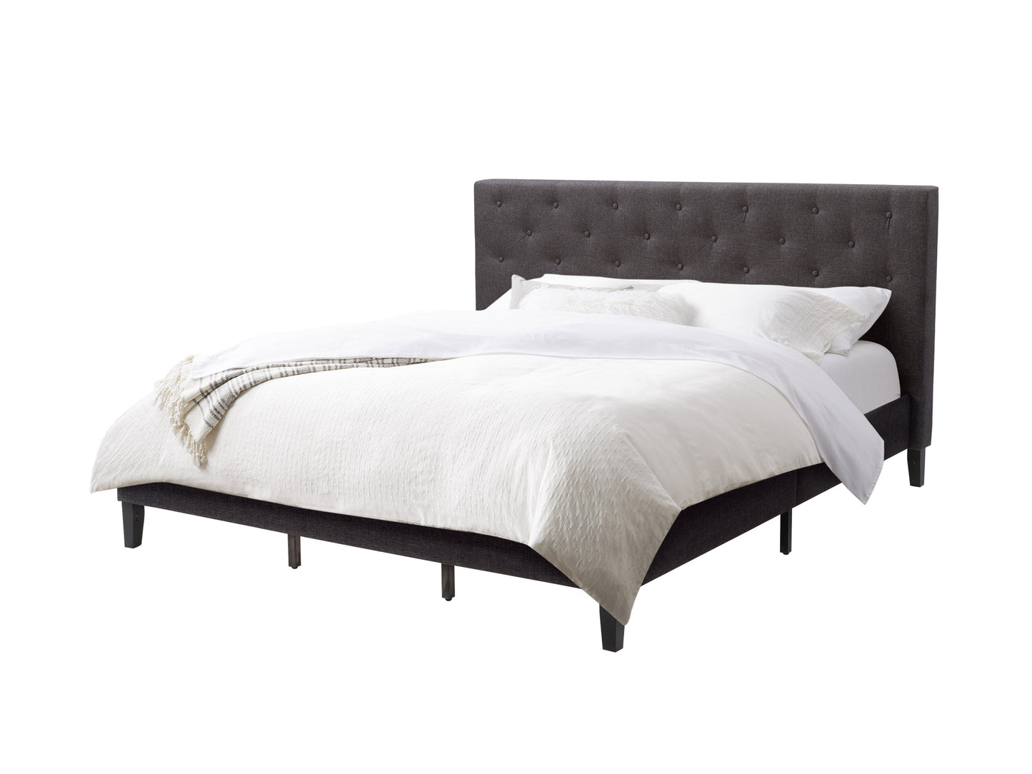 Dark grey button tufted king bed with upholstered headboard and wooden frame.