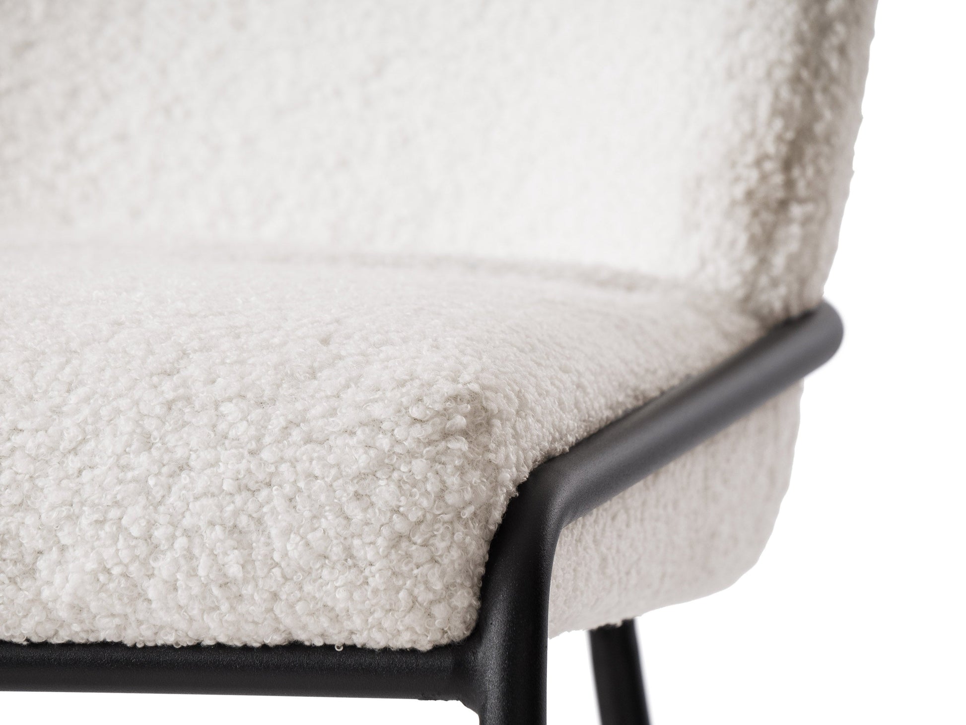 White boucle bar stool with curved backrest, sleek wooden legs, and modern design.