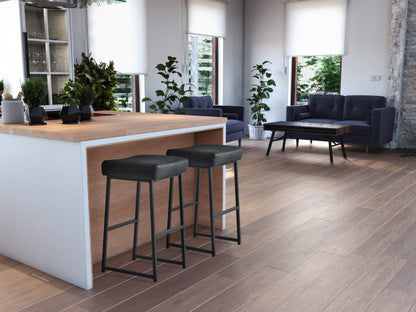 Set of 2 black backless bar stools with metal legs and cushioned seats, perfect for modern kitchen or bar areas.