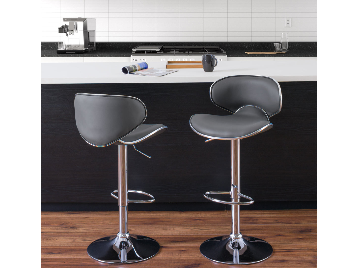 Set of 2 dark grey bar stools with cushioned seats, sleek metal legs, and footrests. Upholstered in soft fabric with a modern design, perfect for kitchen islands or home bars.