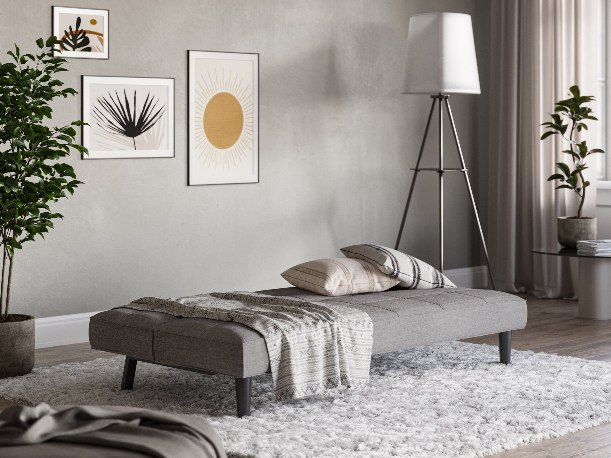 Light grey futon sofa bed with tufted cushions, wooden legs, and modern design.