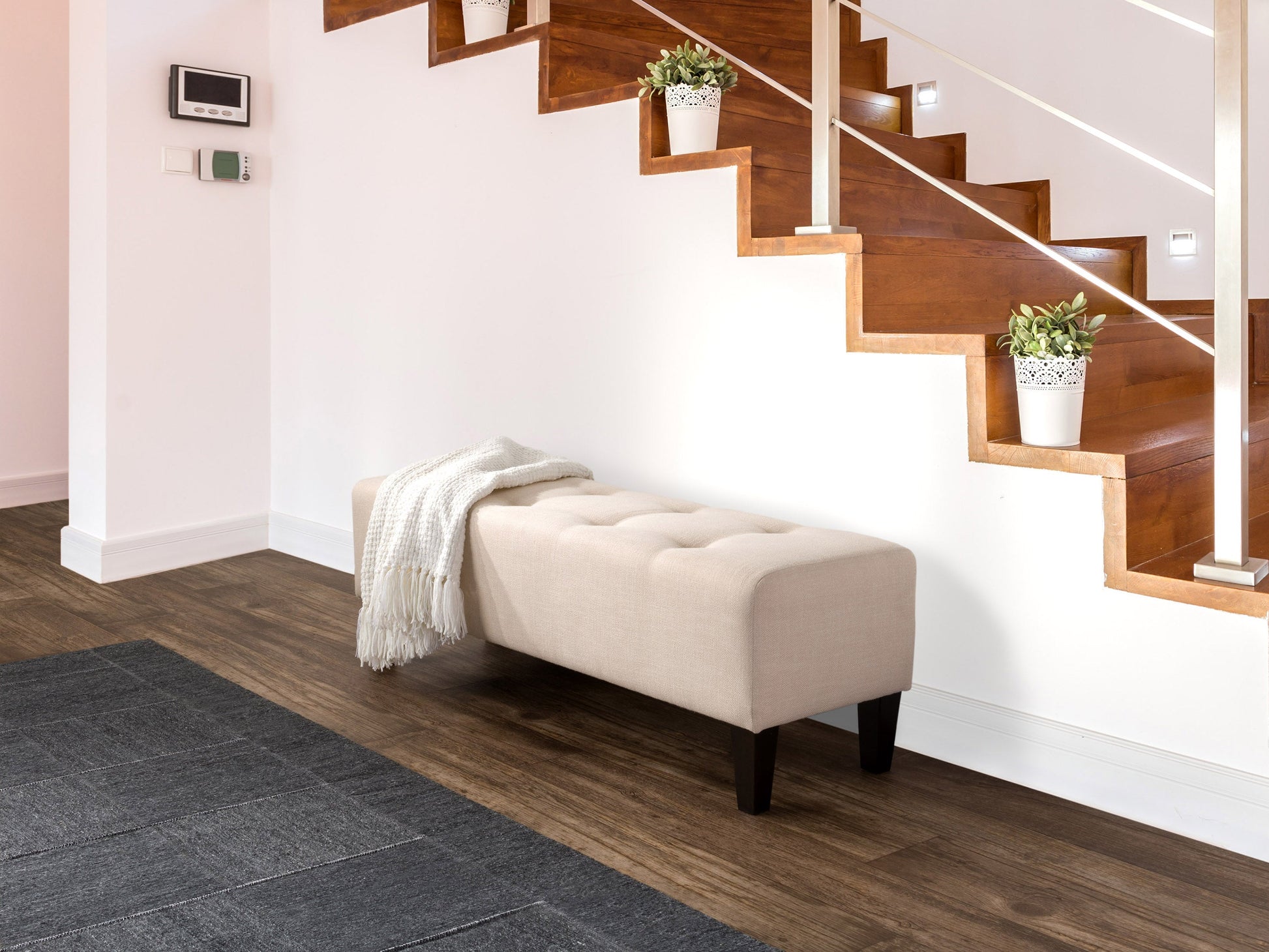 Cream accent bench with tufted fabric, wooden legs, and a modern minimalist design.