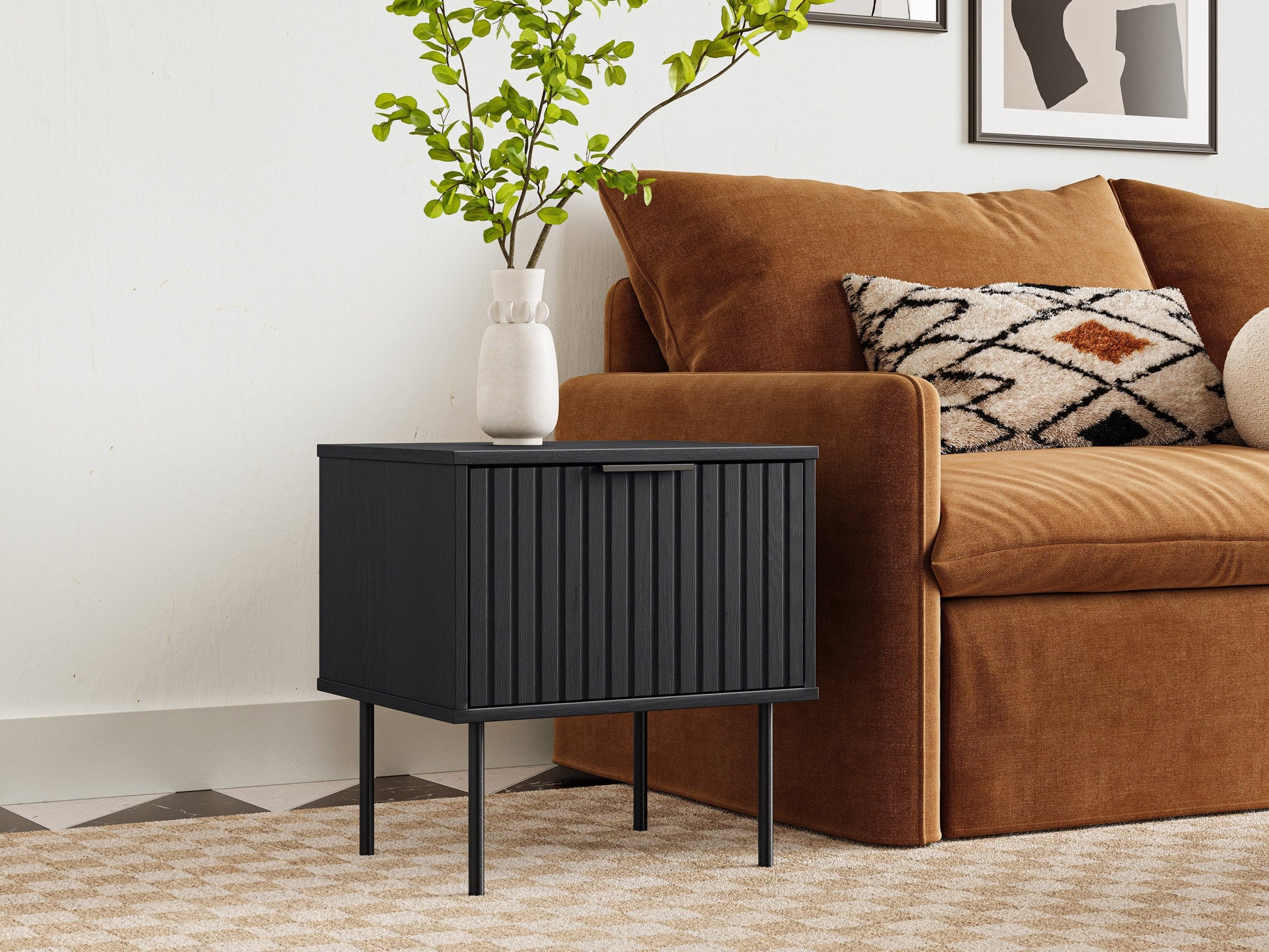 Black fluted side table with round top, ribbed texture, and sleek modern design.