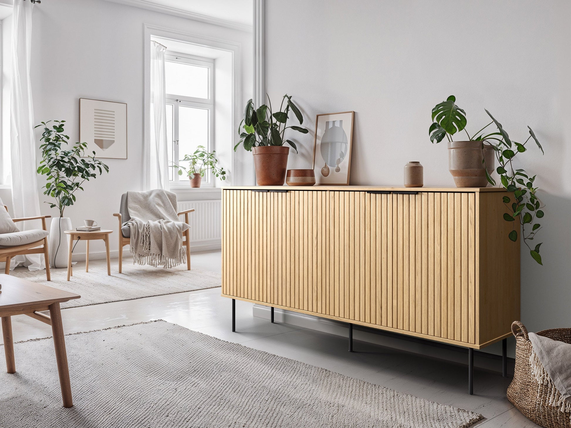 Light wood sideboard with three drawers and two cabinets, featuring sleek black metal handles and a minimalist design.