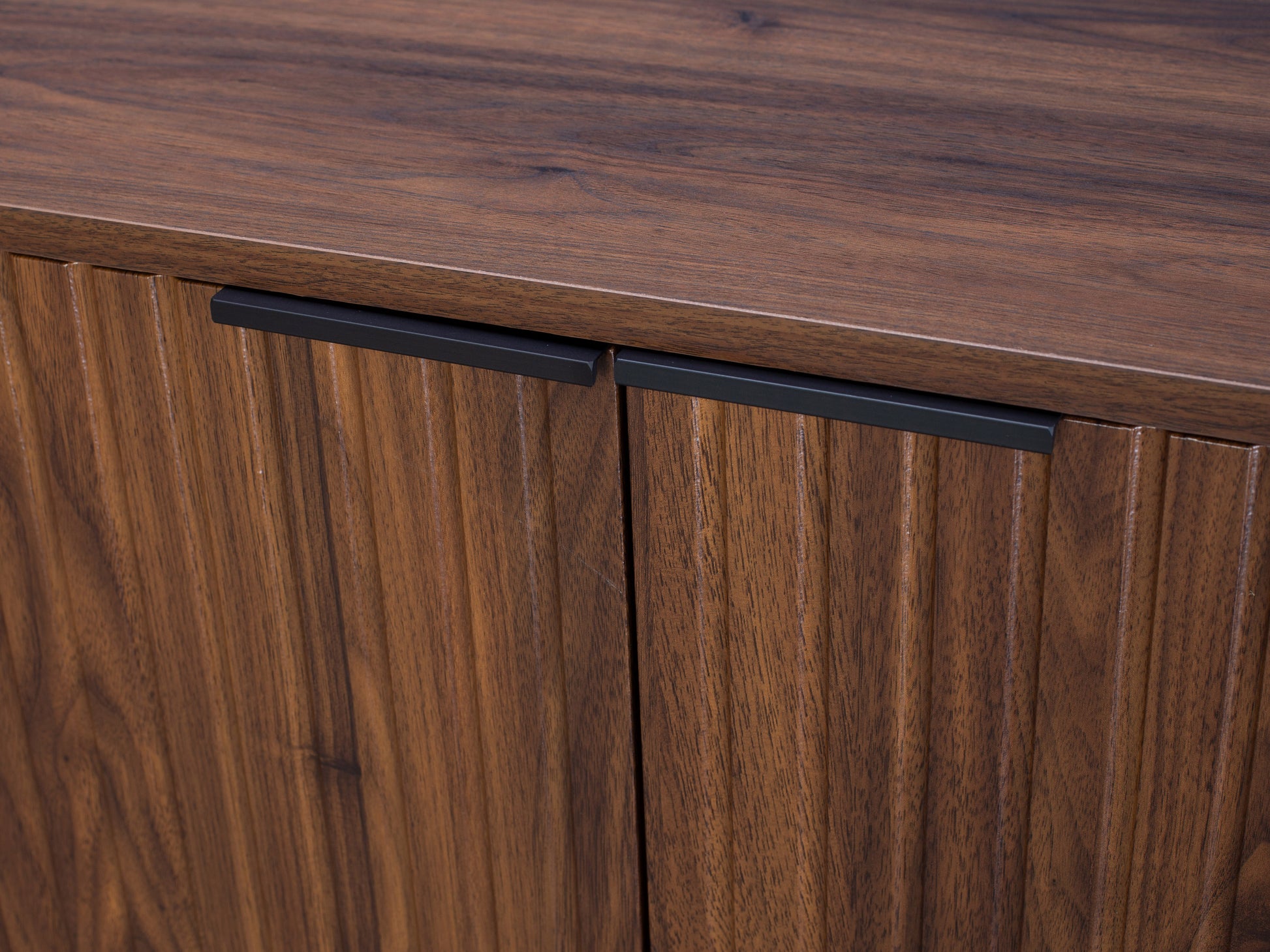 Fluted walnut sideboard cabinet with elegant detailing, featuring dark walnut finish, fluted texture, and minimalist design.