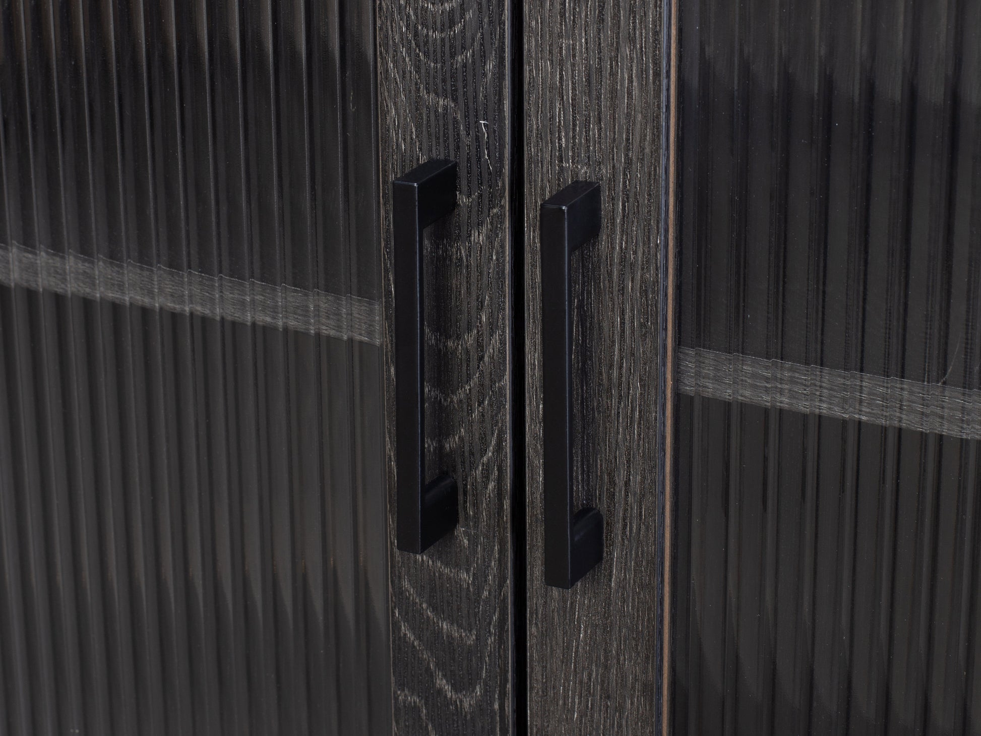 Fluted glass sideboard with black metal frame, featuring ribbed glass doors, sleek handles, and a modern design.
