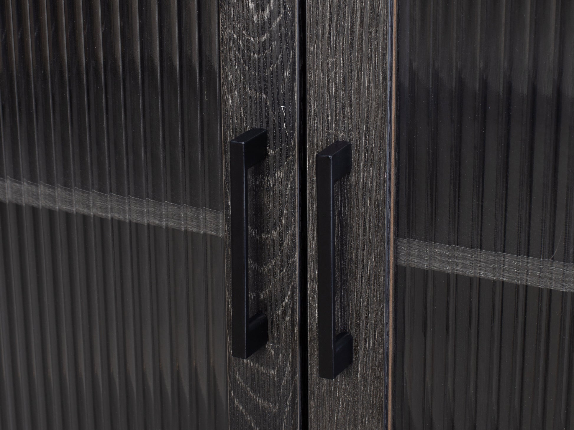 Fluted glass buffet cabinet with black metal frame, light wood finish, and textured glass doors featuring vertical ribbed patterns. Elegant dining storage solution with modern design and ample space for dishware.