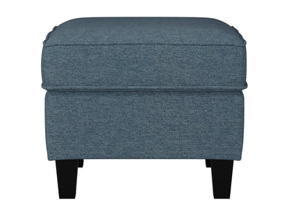 Blue fabric ottoman with wooden legs, tufted top, and modern minimalist design.