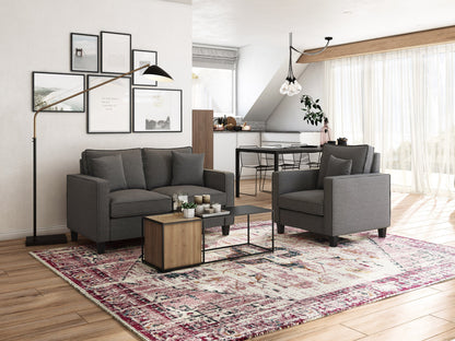 Mid-century modern grey arm chair with tufted back, wooden legs, and comfortable upholstery.