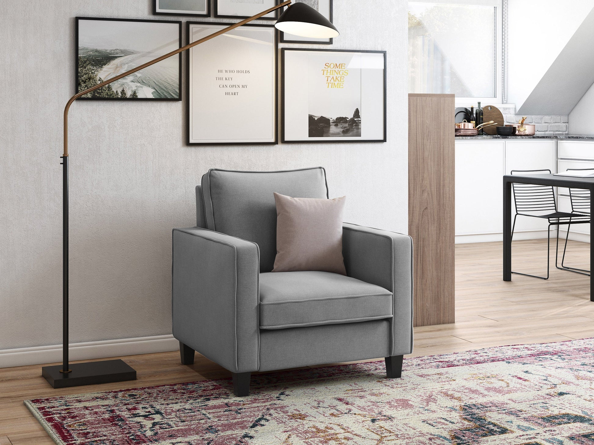 Mid-century modern light grey arm chair with wooden legs, tufted cushions, and stylish design.