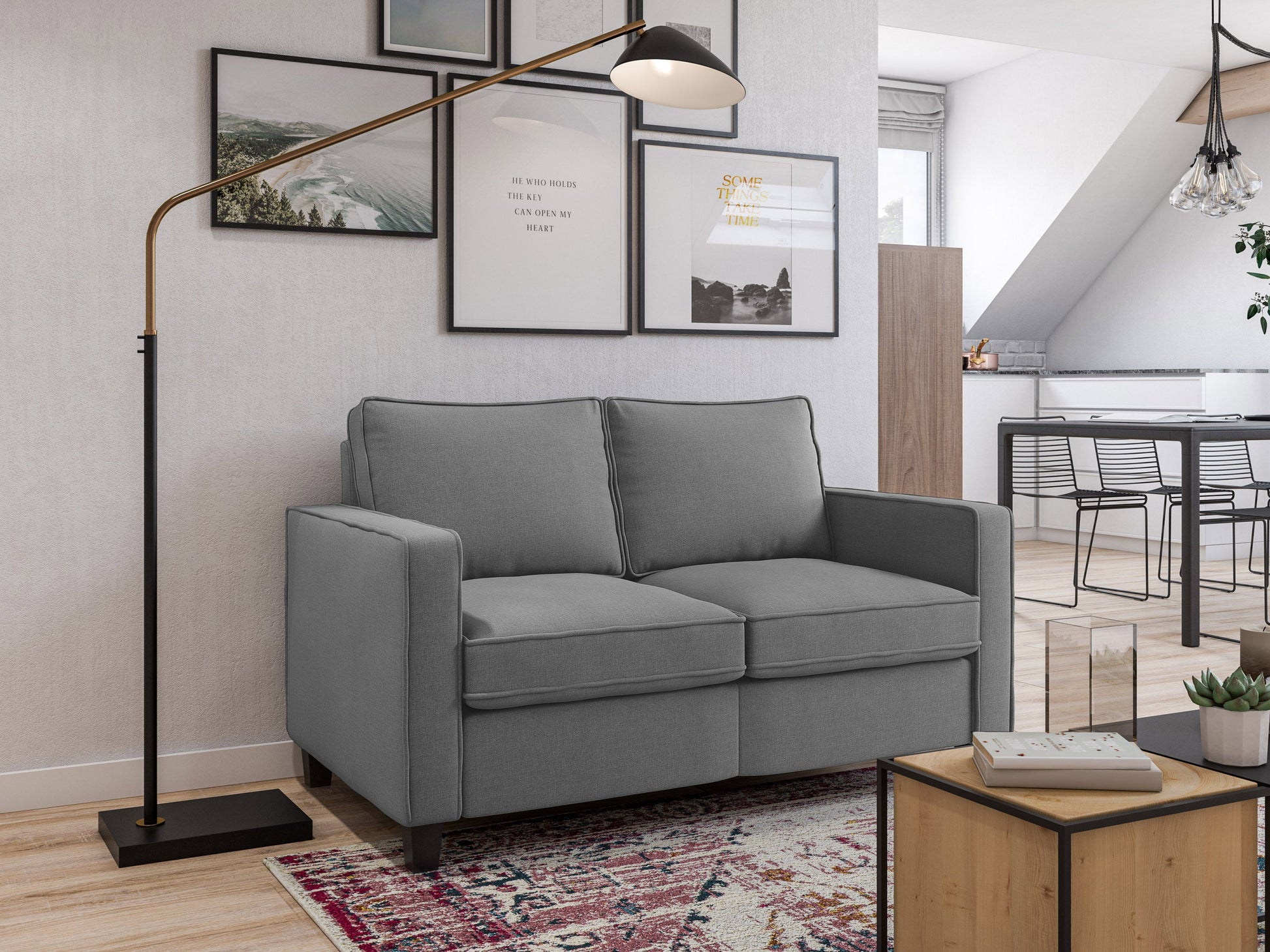 Grey 2 seater loveseat with tufted cushions, wooden legs, and modern minimalist design.
