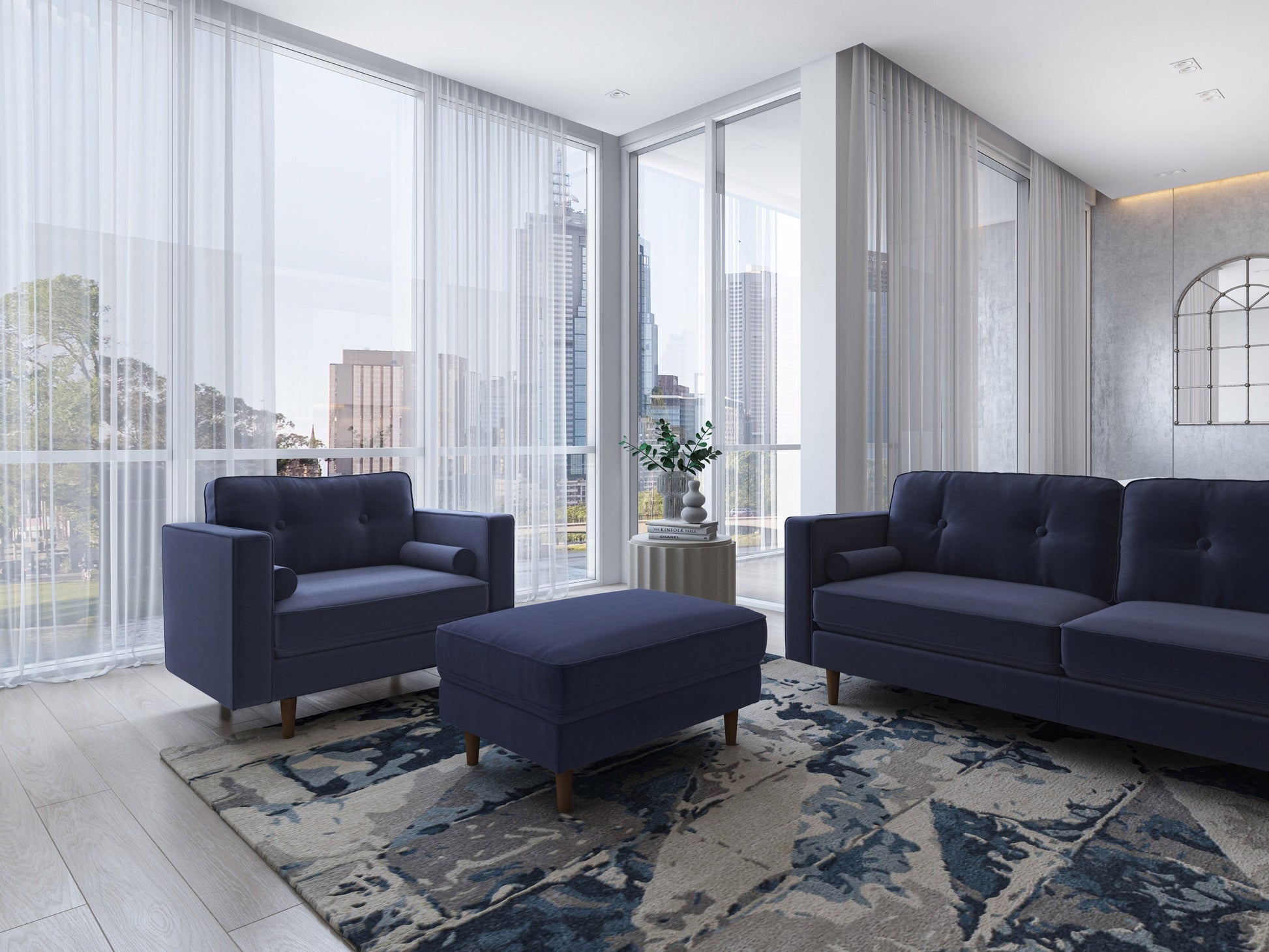 Navy blue accent chair with ottoman, velvet upholstery, sleek black metal legs, and tufted cushions.