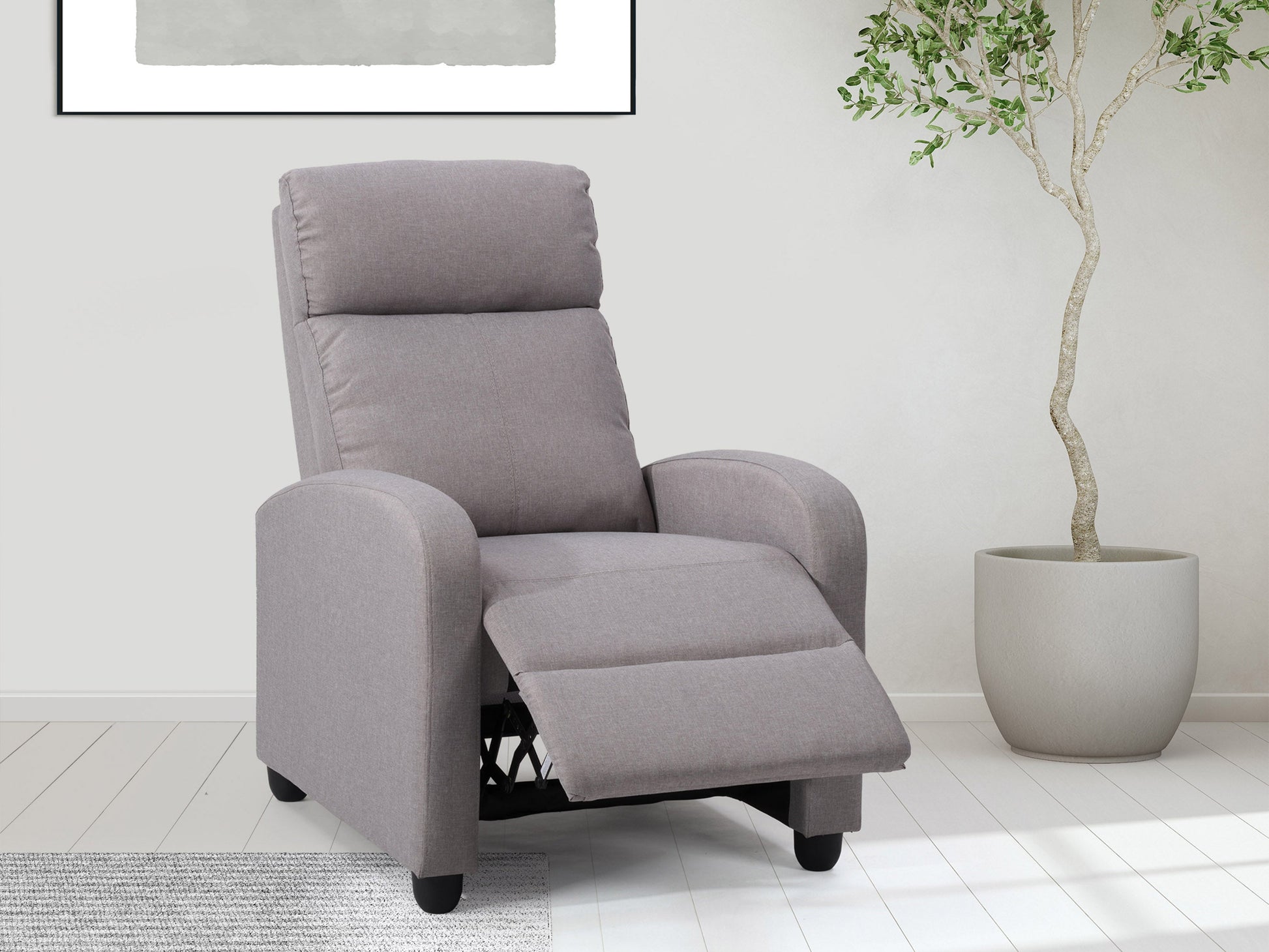 Light grey push back recliner with tufted backrest, wooden legs, and soft fabric upholstery.