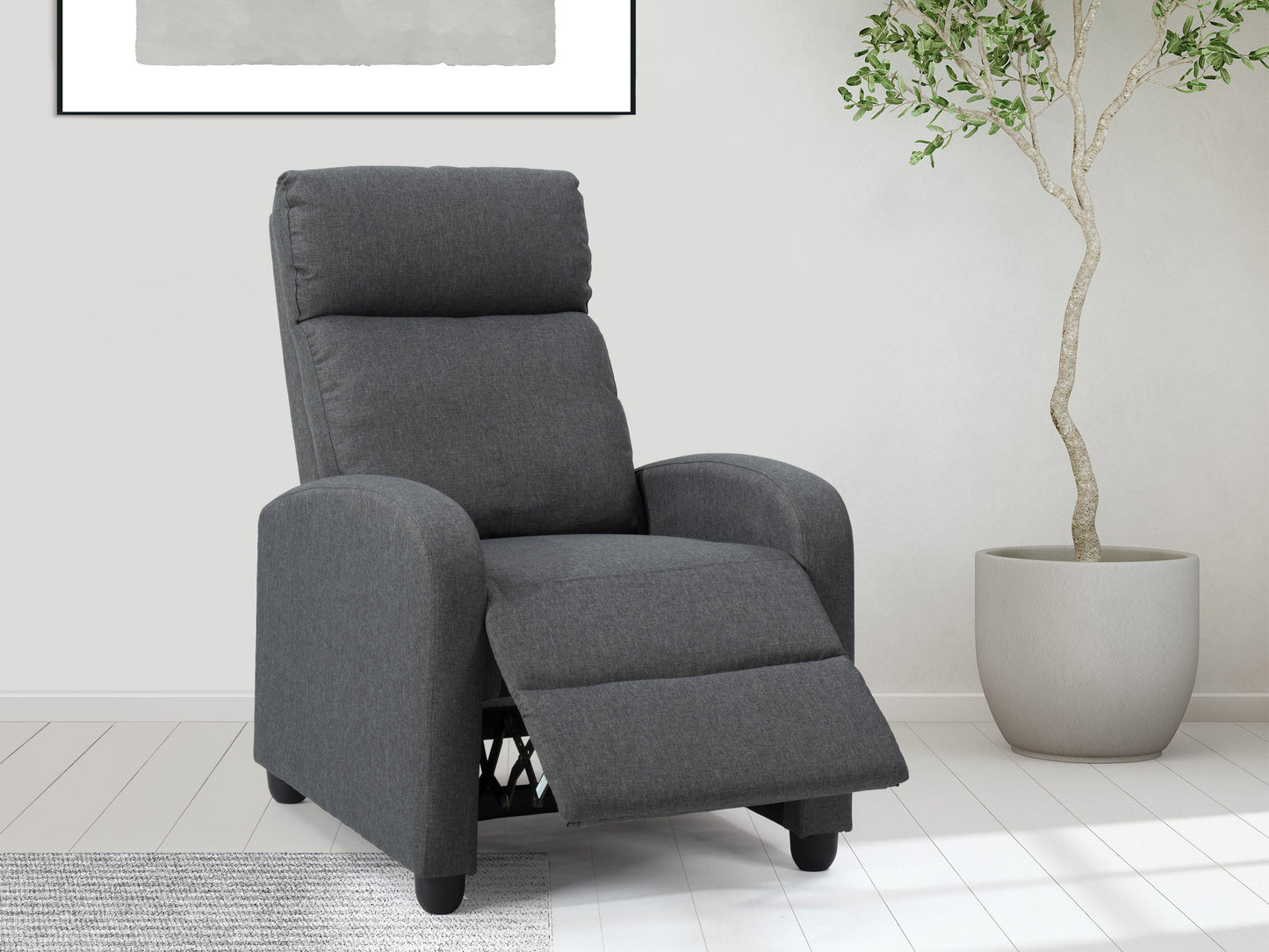 Dark grey push back recliner with tufted backrest, wooden legs, and soft fabric upholstery.