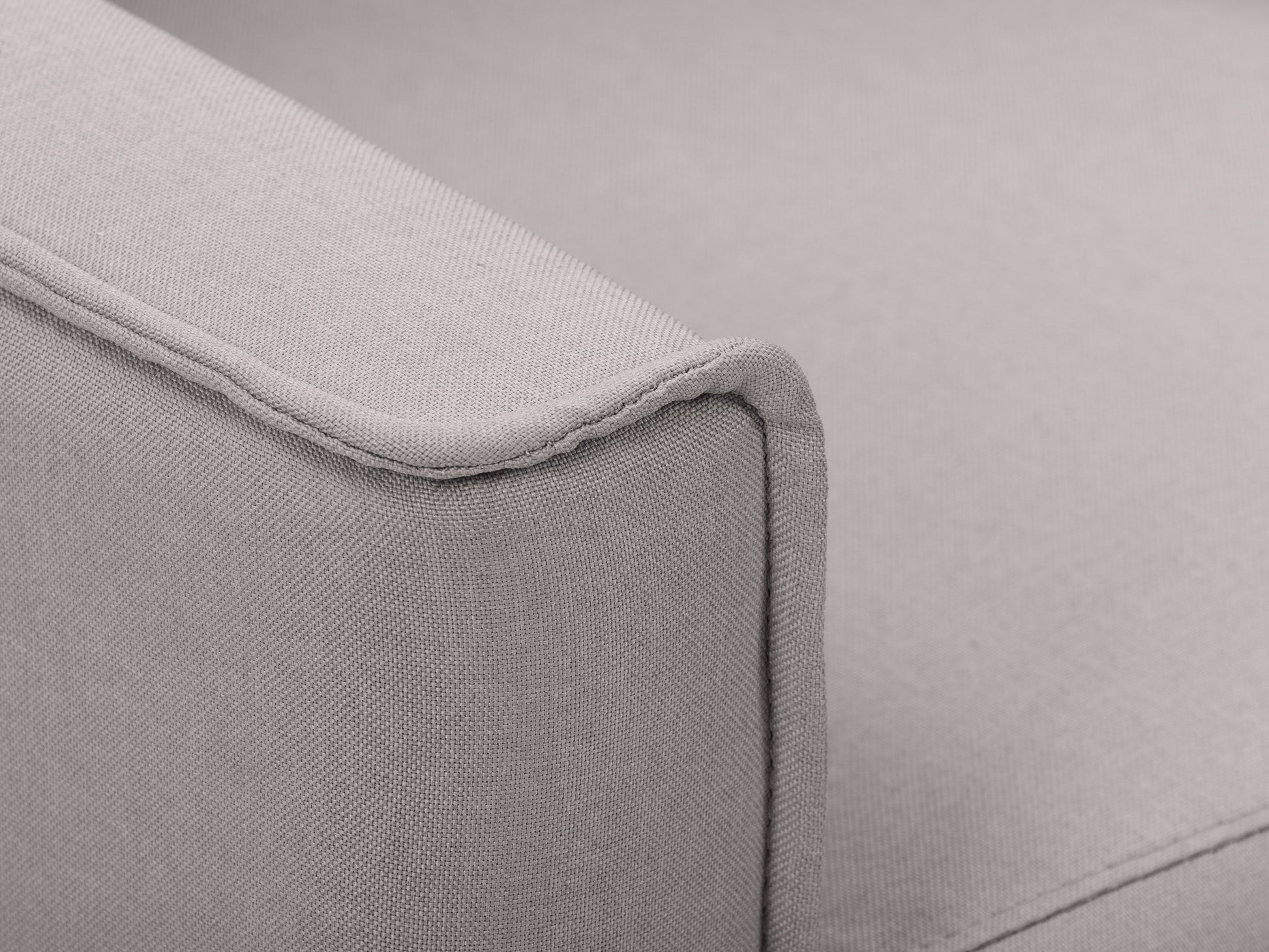 Light grey mid-century recliner with wooden legs, tufted backrest, and sleek design.