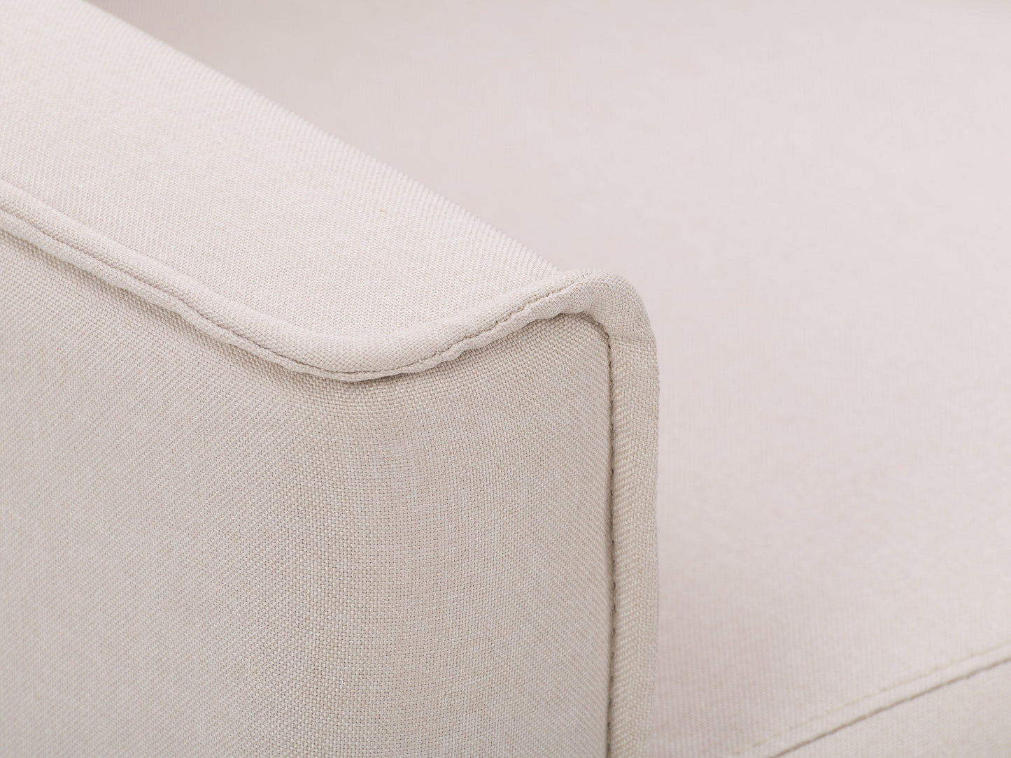 Beige mid-century recliner with wooden legs, tufted backrest, and sleek armrests.