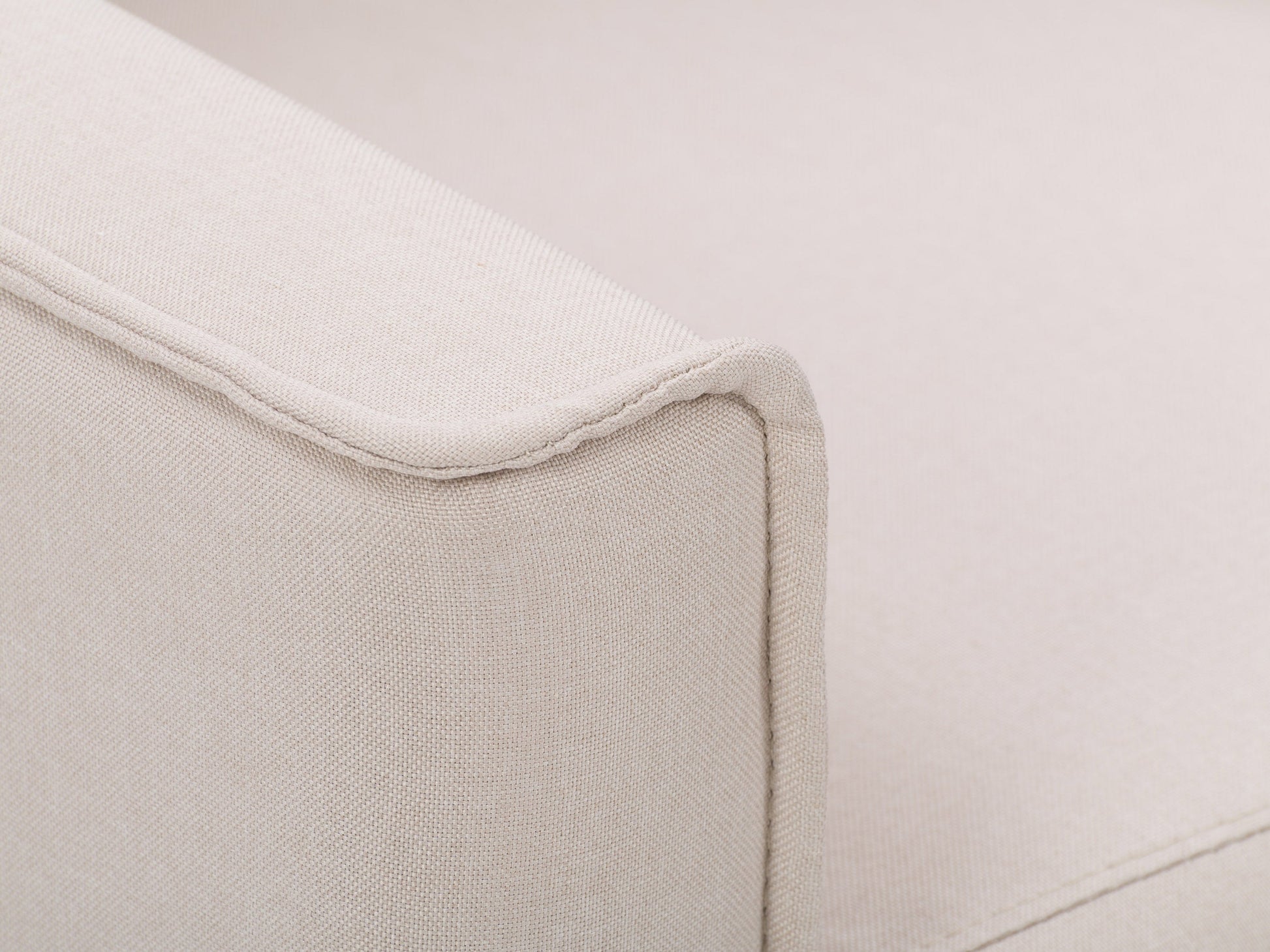 Beige mid-century recliner with wooden legs, tufted backrest, and sleek armrests.