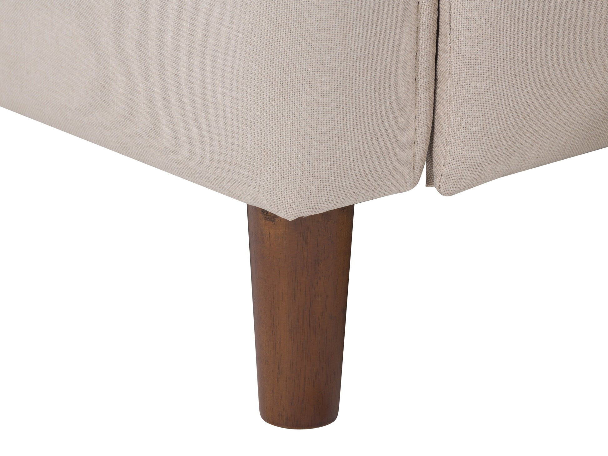 Mid-century beige recliner with wooden legs, tufted backrest, and soft fabric upholstery.