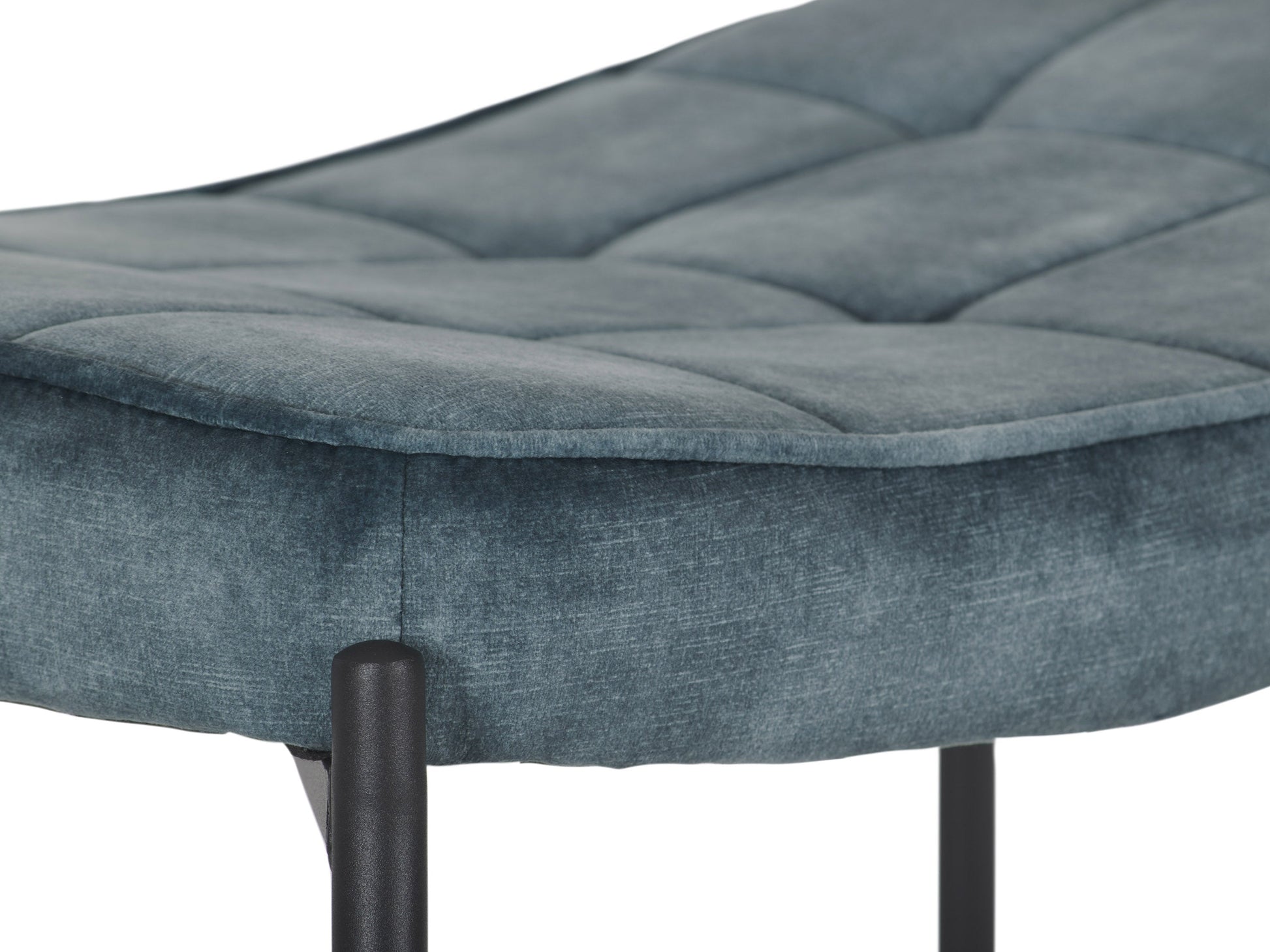 Dark teal velvet accent chair with matching ottoman, tufted backrest, and sleek wooden legs.