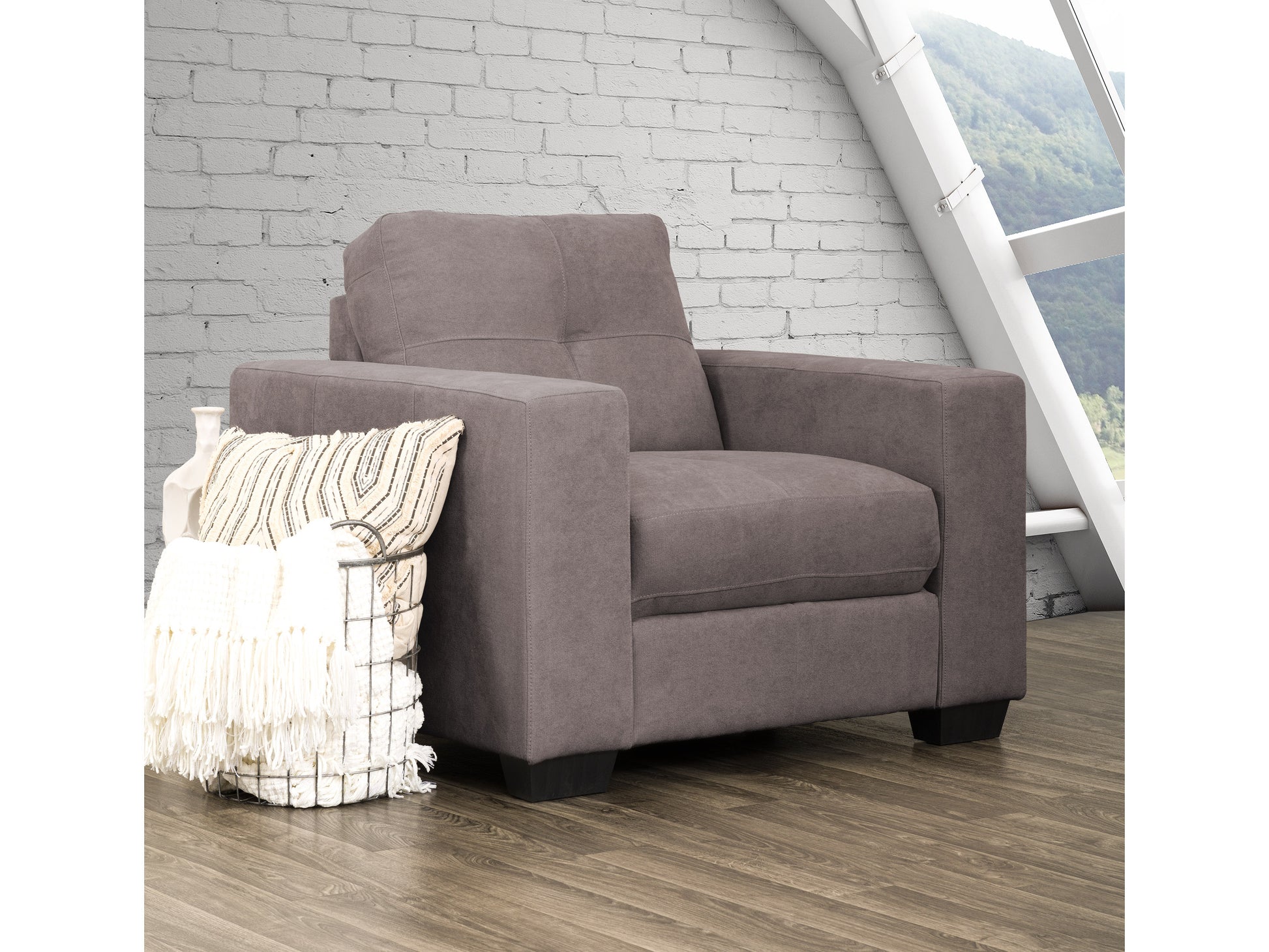 Wide armchair with plush, light gray upholstery, featuring wide armrests and a sturdy wooden frame. Perfect for modern living rooms, offering comfortable seating and a sleek, contemporary design.