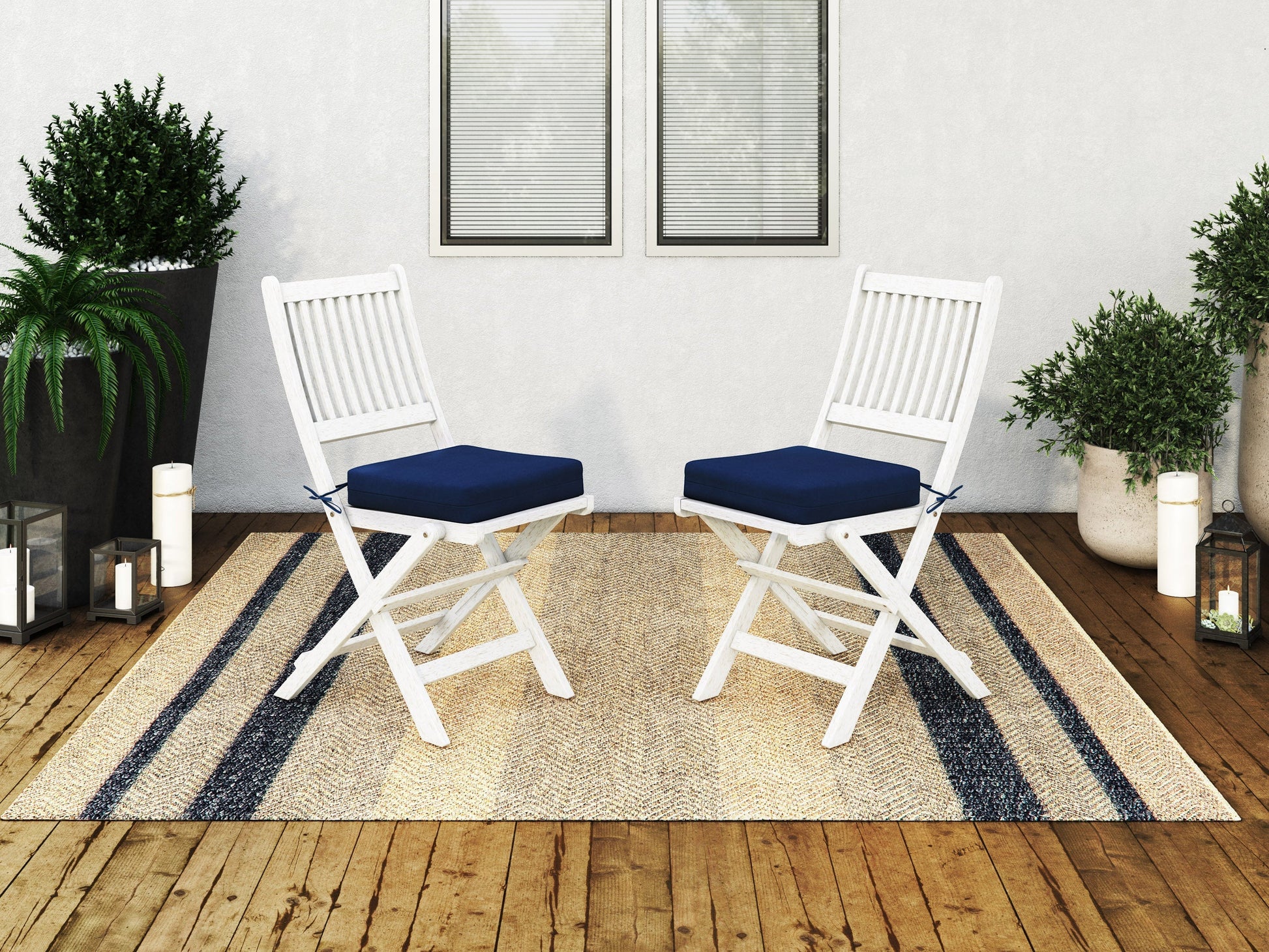Set of 2 washed white outdoor wood folding chairs with slatted seats and backs, perfect for patio or garden use.