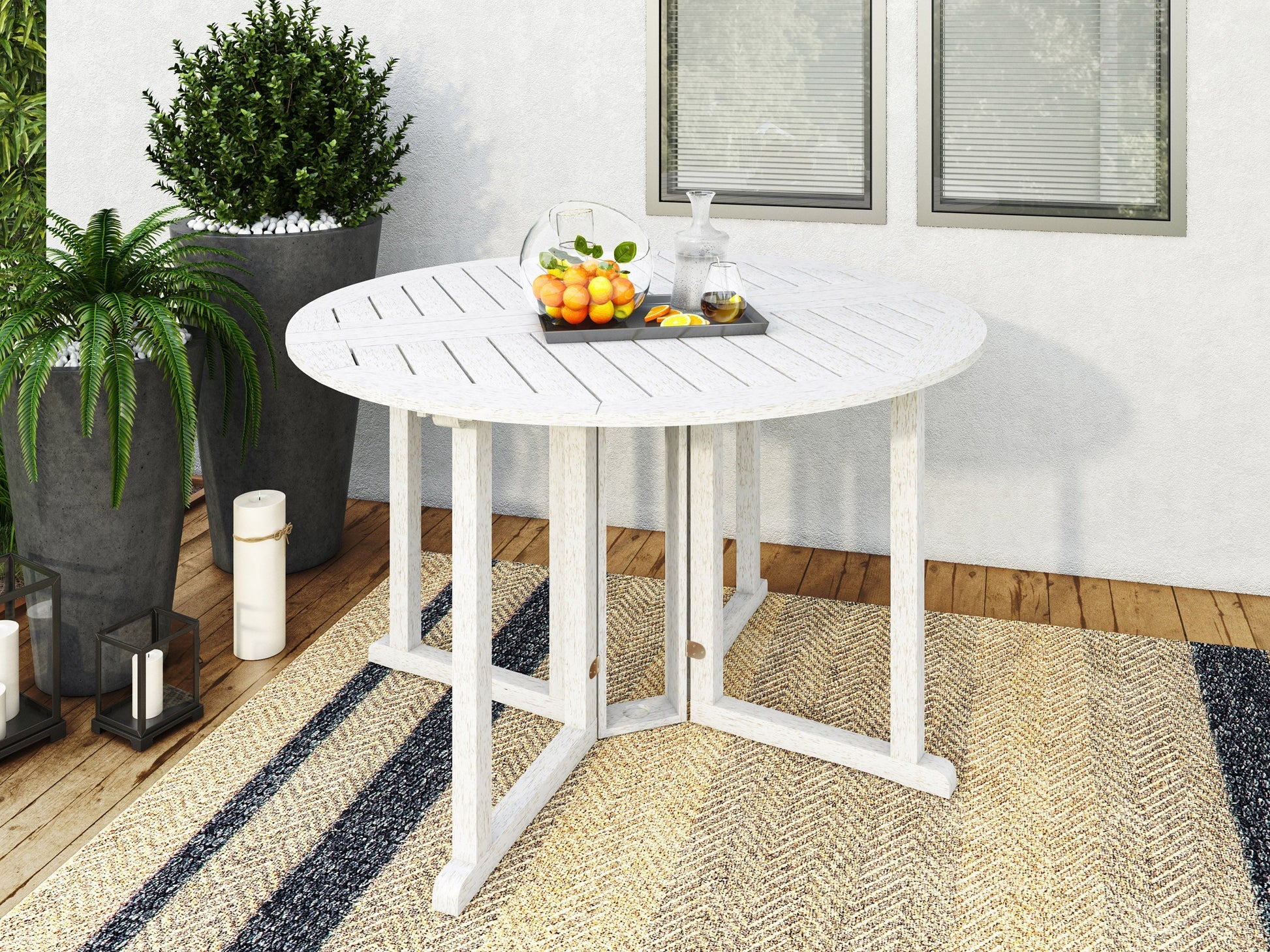 Washed white outdoor drop leaf patio table with foldable sides and weather-resistant finish.