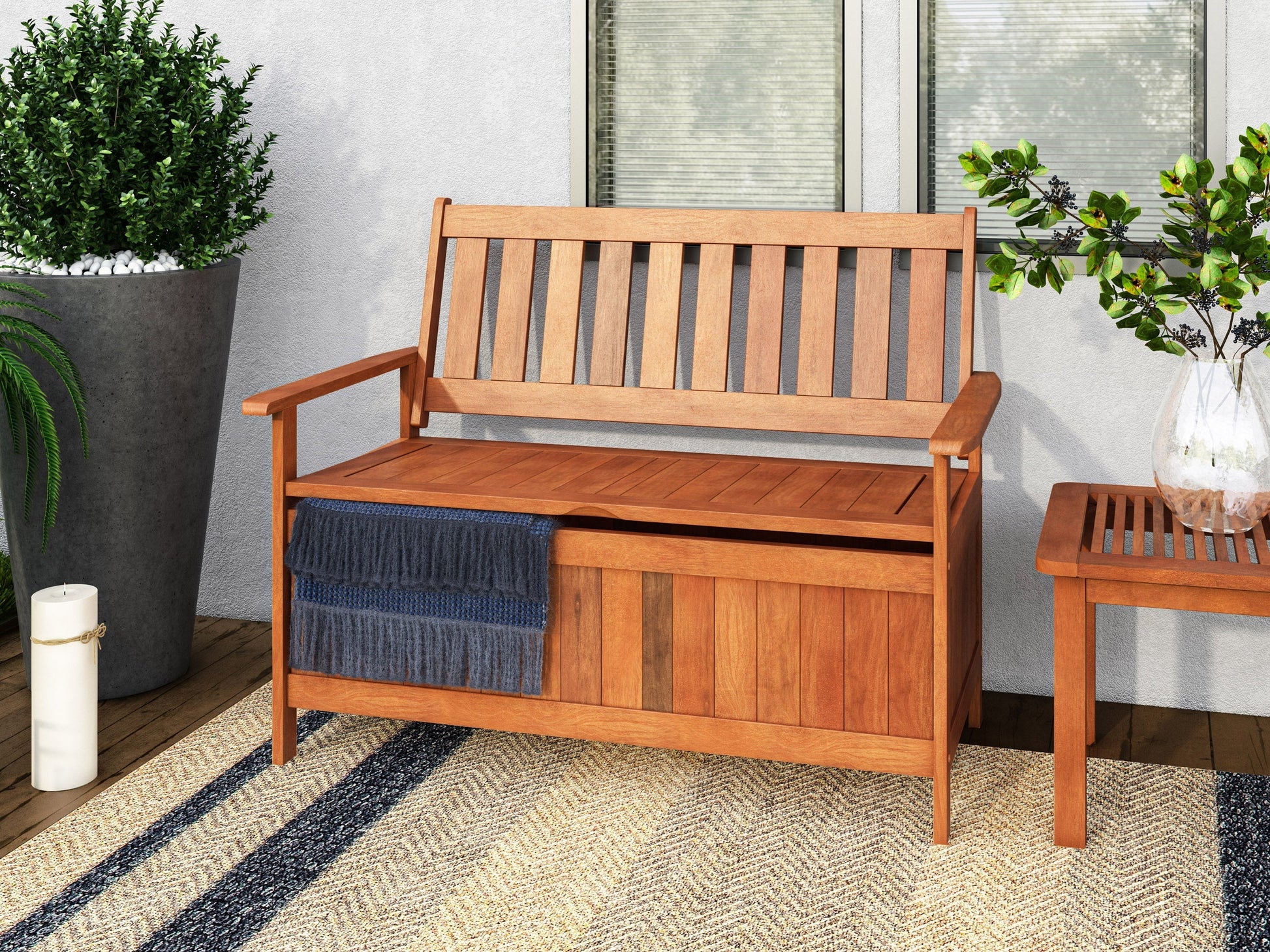 Brown wooden patio storage bench with slatted seat, armrests, and backrest, ideal for outdoor seating and storage.
