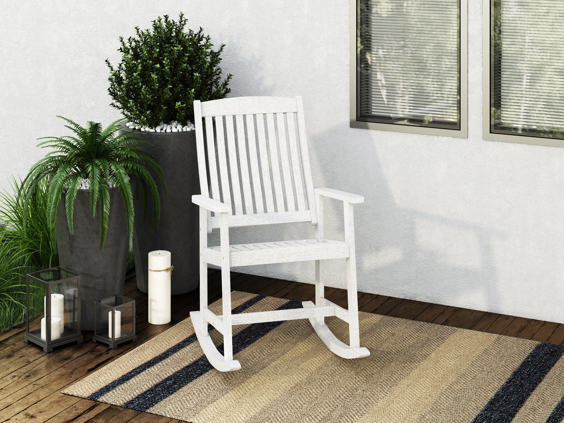 Washed white outdoor rocking chair with curved slatted back, weather-resistant wood, and classic design.