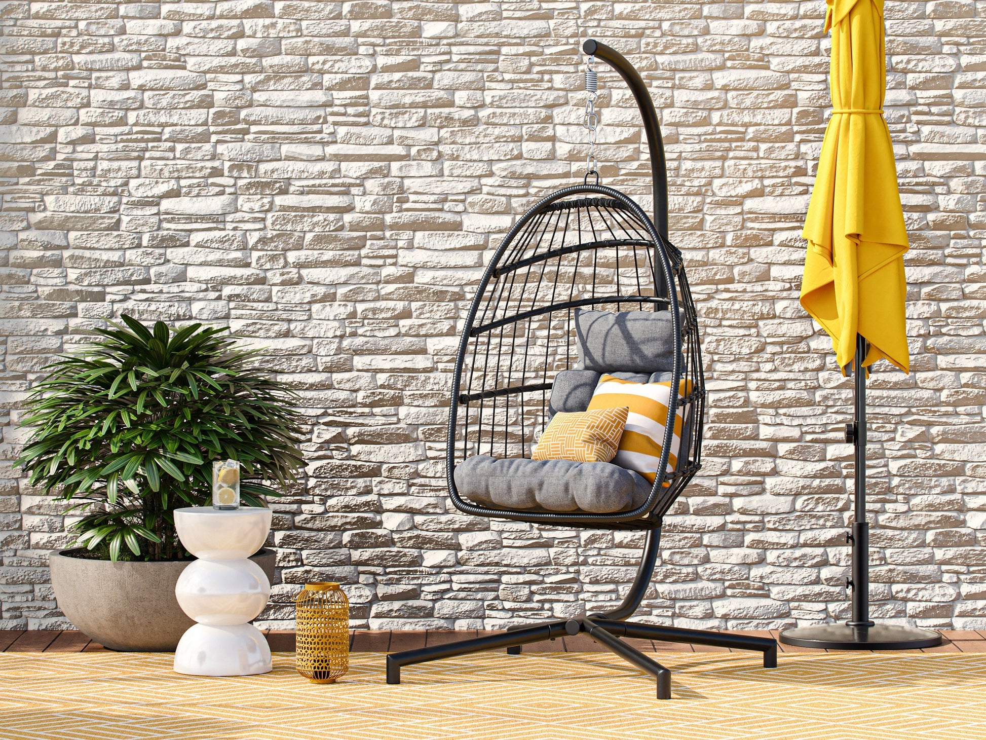 Grey hanging egg chair with cushion, patio swing, wicker design, and sturdy metal stand for outdoor relaxation.