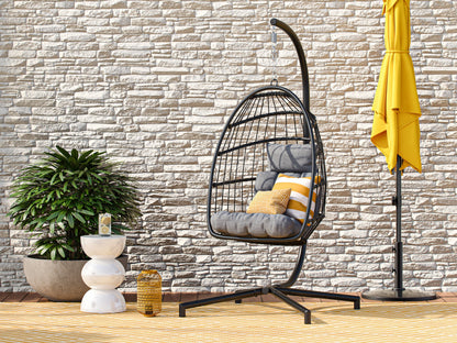 Grey hanging egg chair with cushion, patio swing, wicker design, and sturdy metal stand for outdoor relaxation.