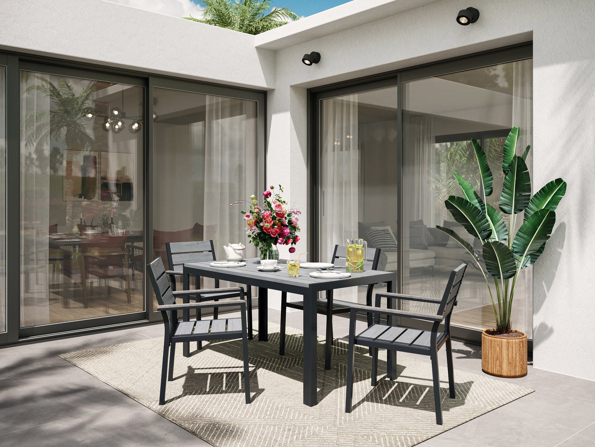 5-piece outdoor patio dining set with grey cushions, dark wicker chairs, and a glass-top table.