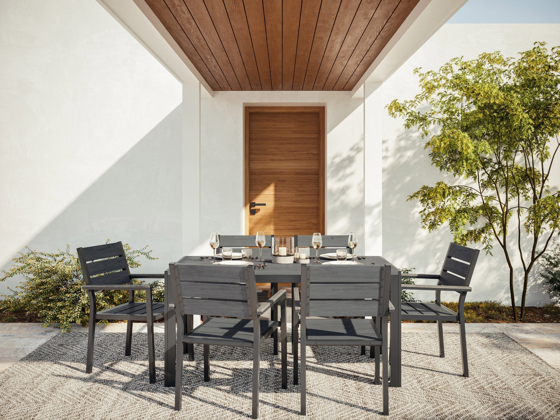 7-piece outdoor patio dining set with grey cushioned chairs and a rectangular wooden table.
