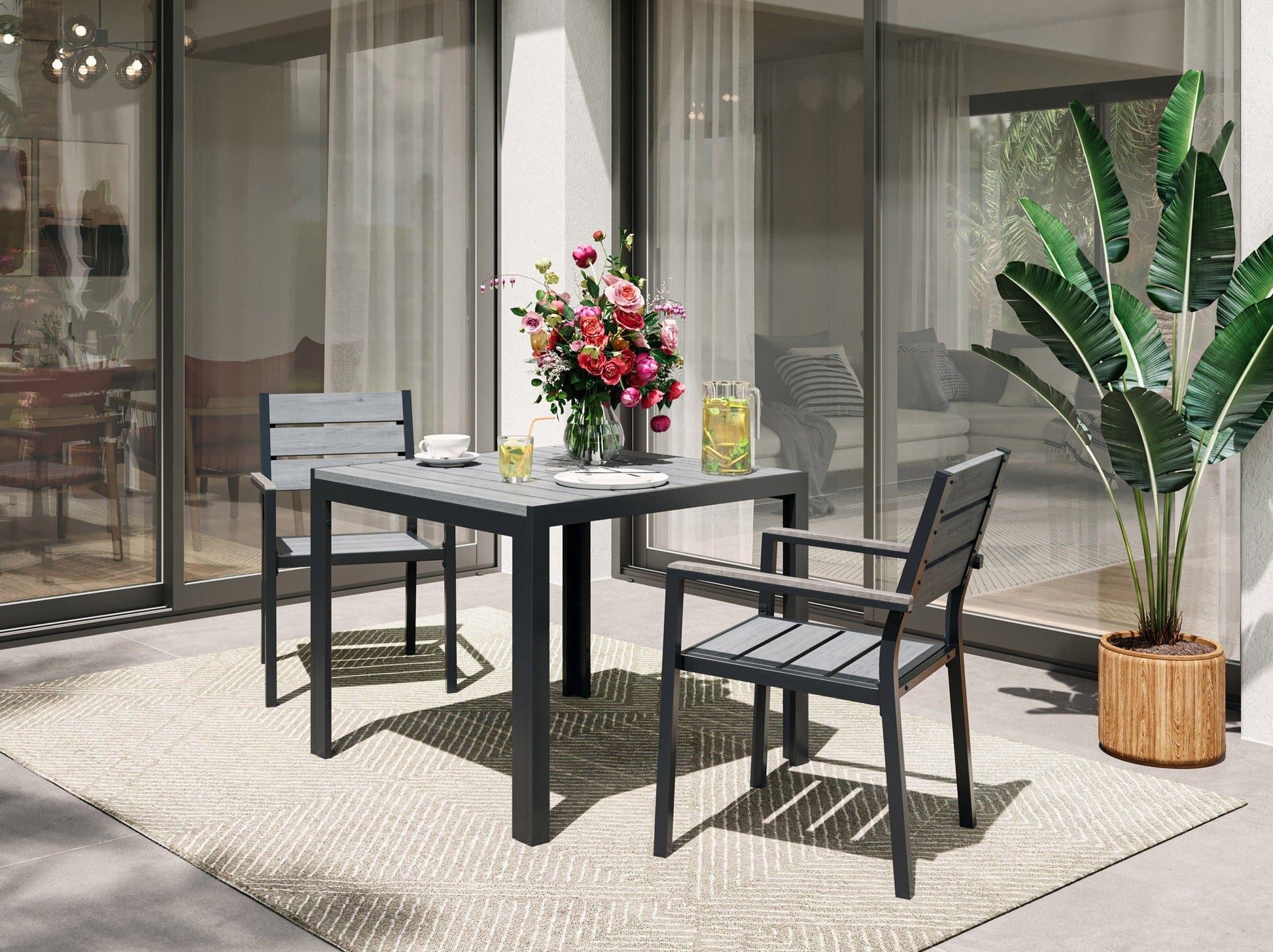 Square outdoor dining table with a sleek grey finish, sturdy metal frame, and weather-resistant surface.