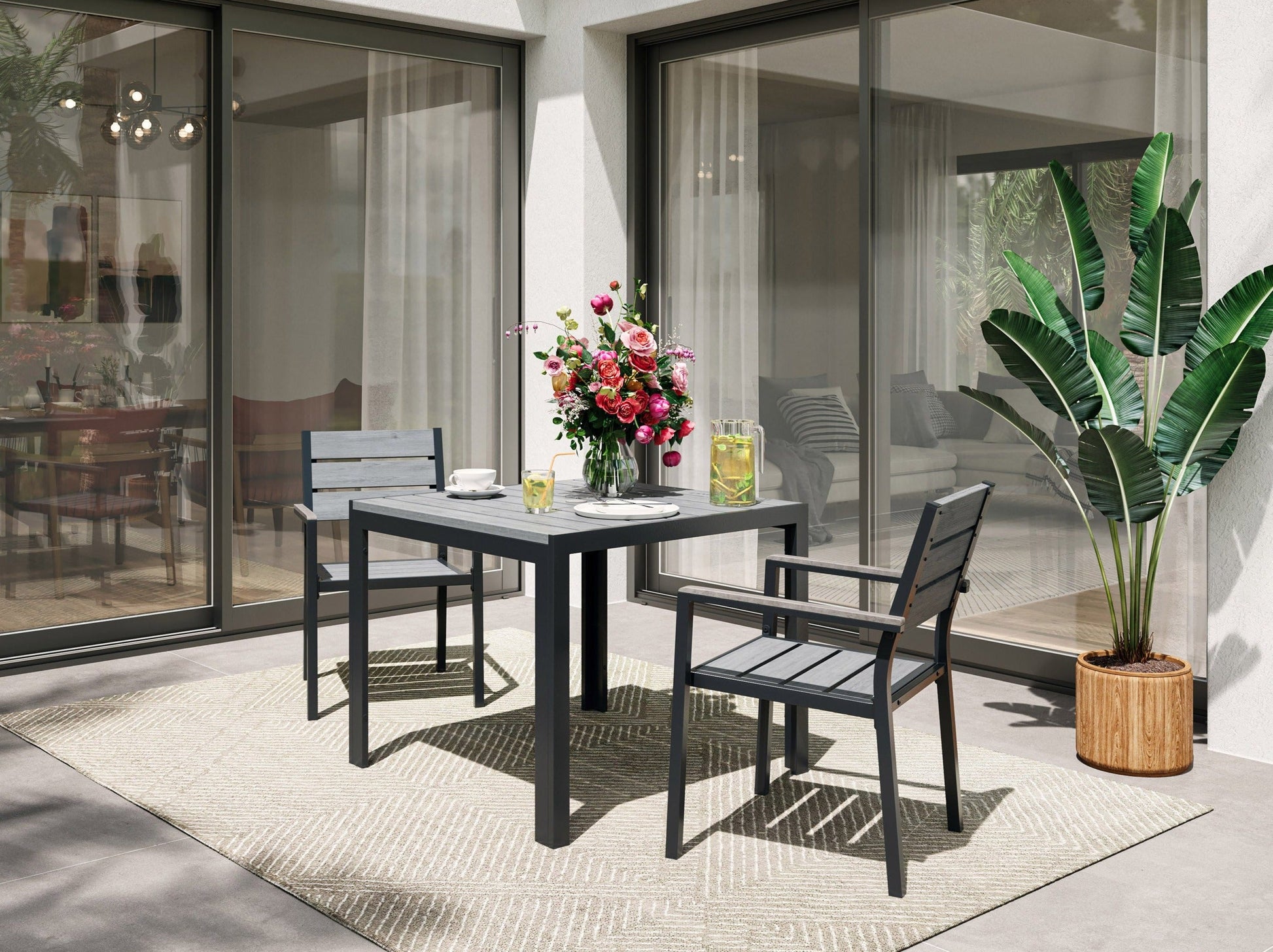 Outdoor patio dining set with dark wicker chairs, glass-top table, and beige cushions, perfect for garden or terrace dining.