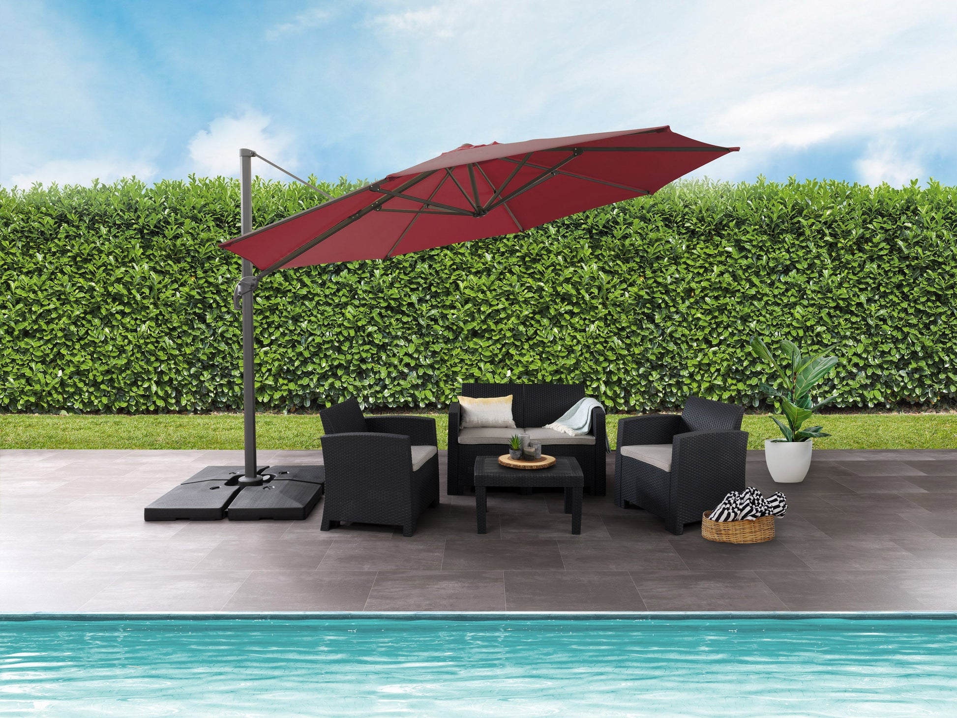 Wine red 11.5ft deluxe offset patio umbrella with sturdy aluminum frame, crank lift system, and UV-resistant fabric, providing ample shade for outdoor seating areas.