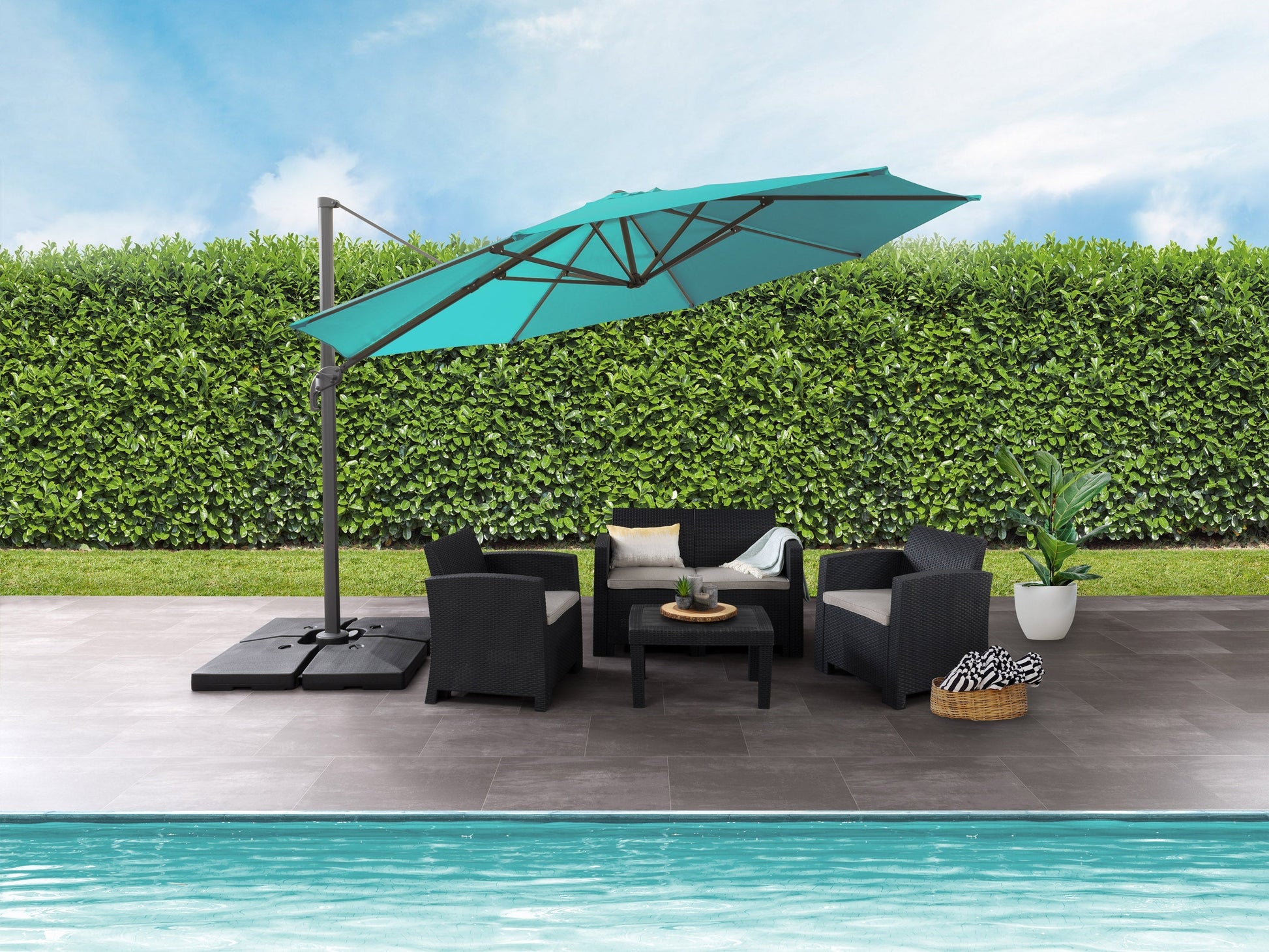 Turquoise 11.5ft deluxe offset patio umbrella with sturdy base and adjustable canopy.