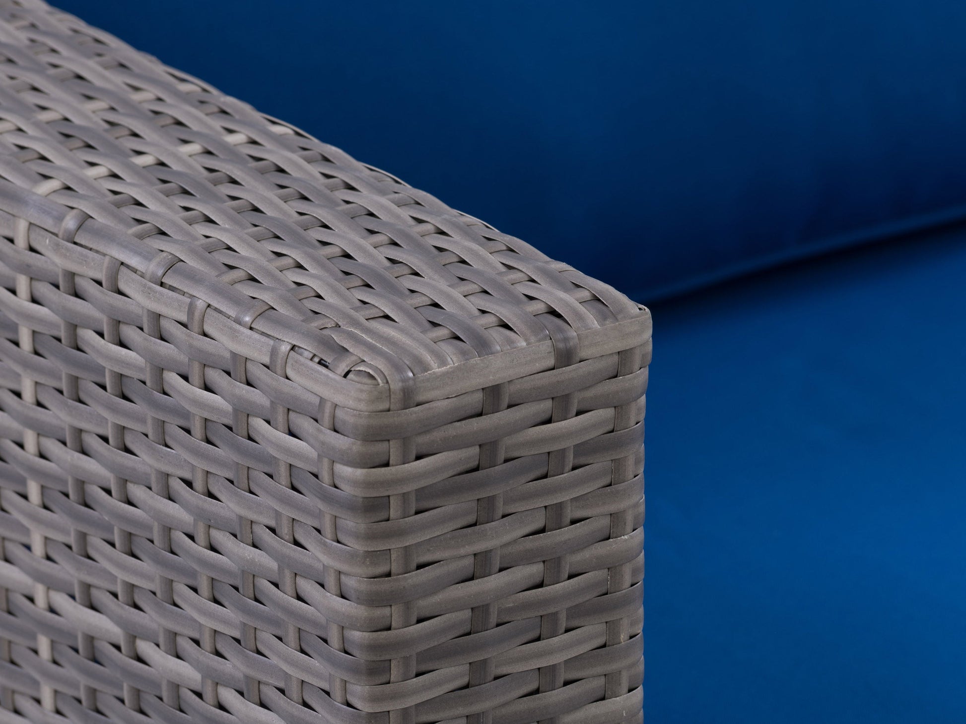 Wicker armchair with natural brown woven texture and white cushioned seat, featuring sturdy wooden legs. Ideal for patio or outdoor seating, blending rustic charm with modern comfort.