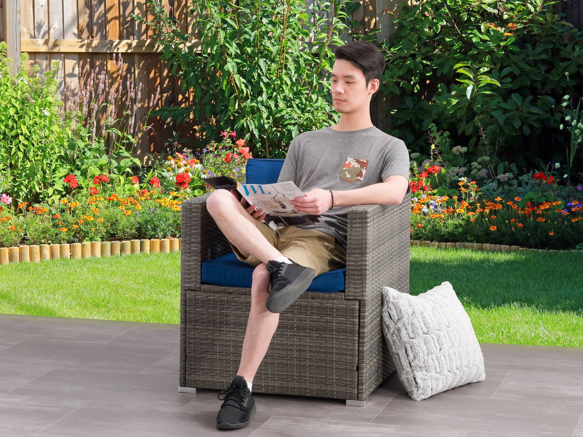 Modern patio chair with sleek black metal frame, light gray cushioned seat and backrest, and minimalist design, perfect for outdoor lounging.